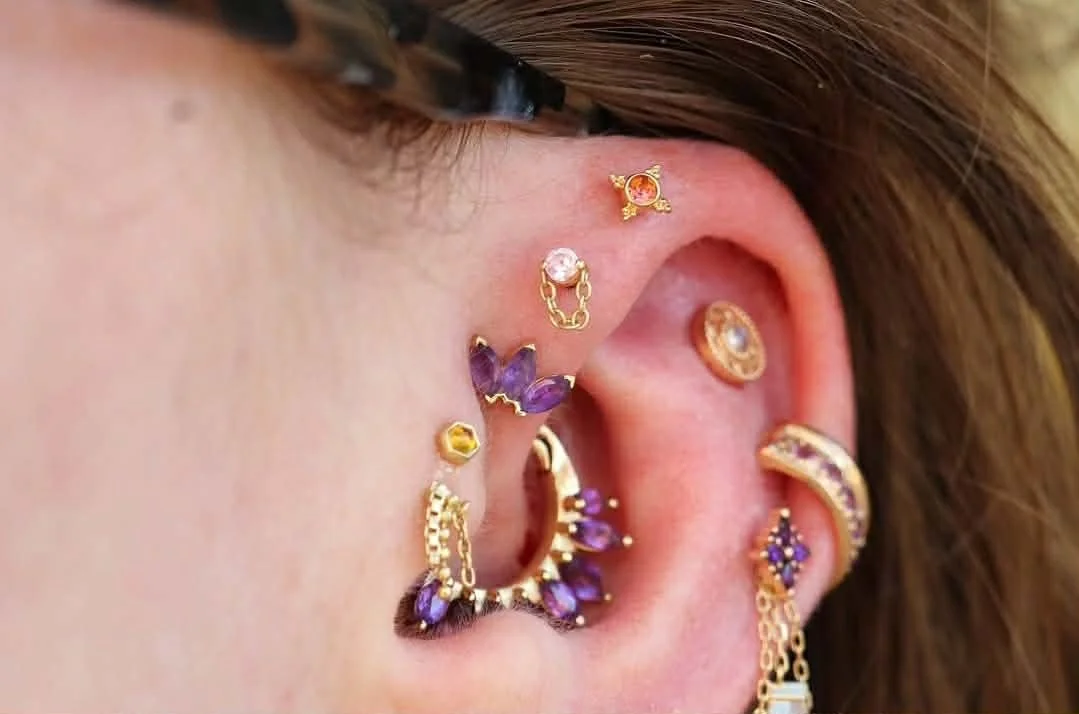 Triple forward helix piercings  with yellow gold
Top - Mini Kandy with Madeira Citrine from BVLA Body Vision Los Angeles
Middle - Pupil Hall Luh you and Pink Sapphire
Bottom - Marquise fan with Amethyst
Ear styling with fine body jewelry - gold