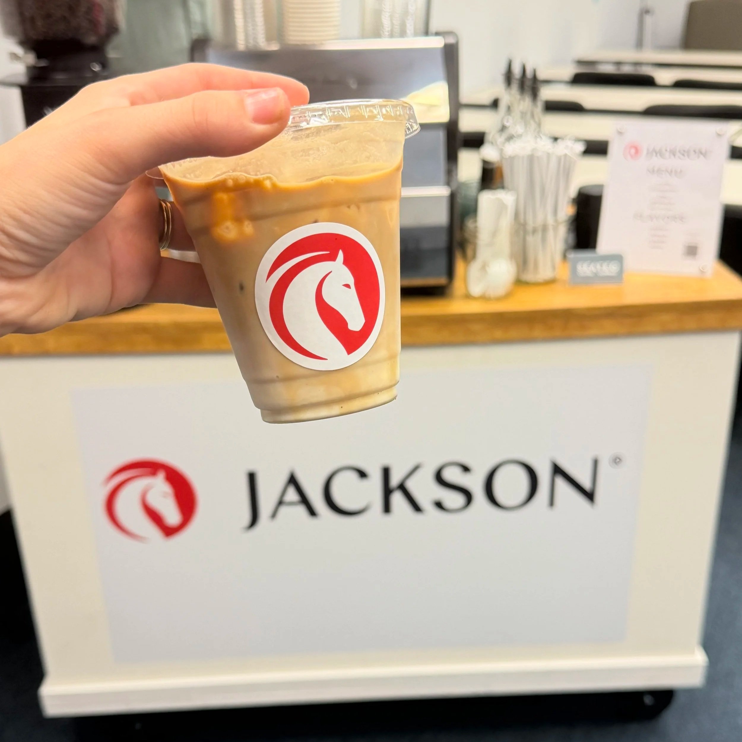 Branded mobile coffee cart providing espresso and specialty drinks at a corporate event