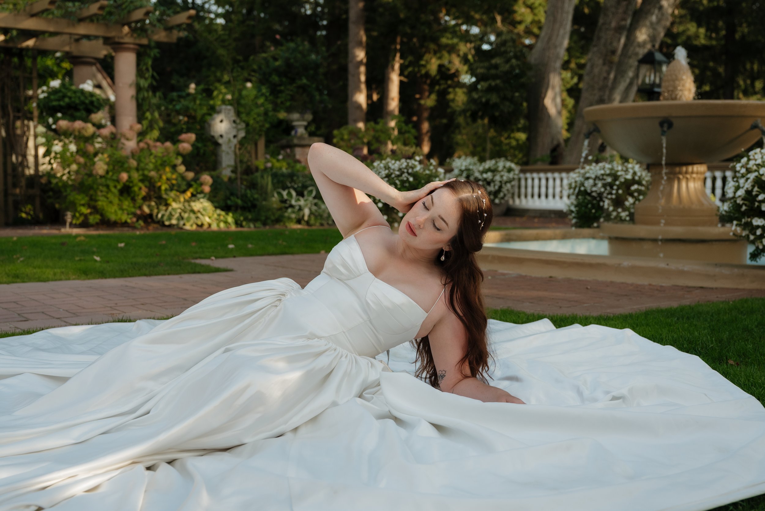 bride laying in grass at lairmont manor bellingham washington