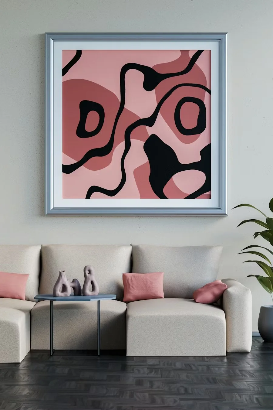 Living room with beige sofa, pink pillows, abstract wall art with pink, black, and brown shapes, three pink ceramic vases on a black side table, and a potted plant in the corner.
