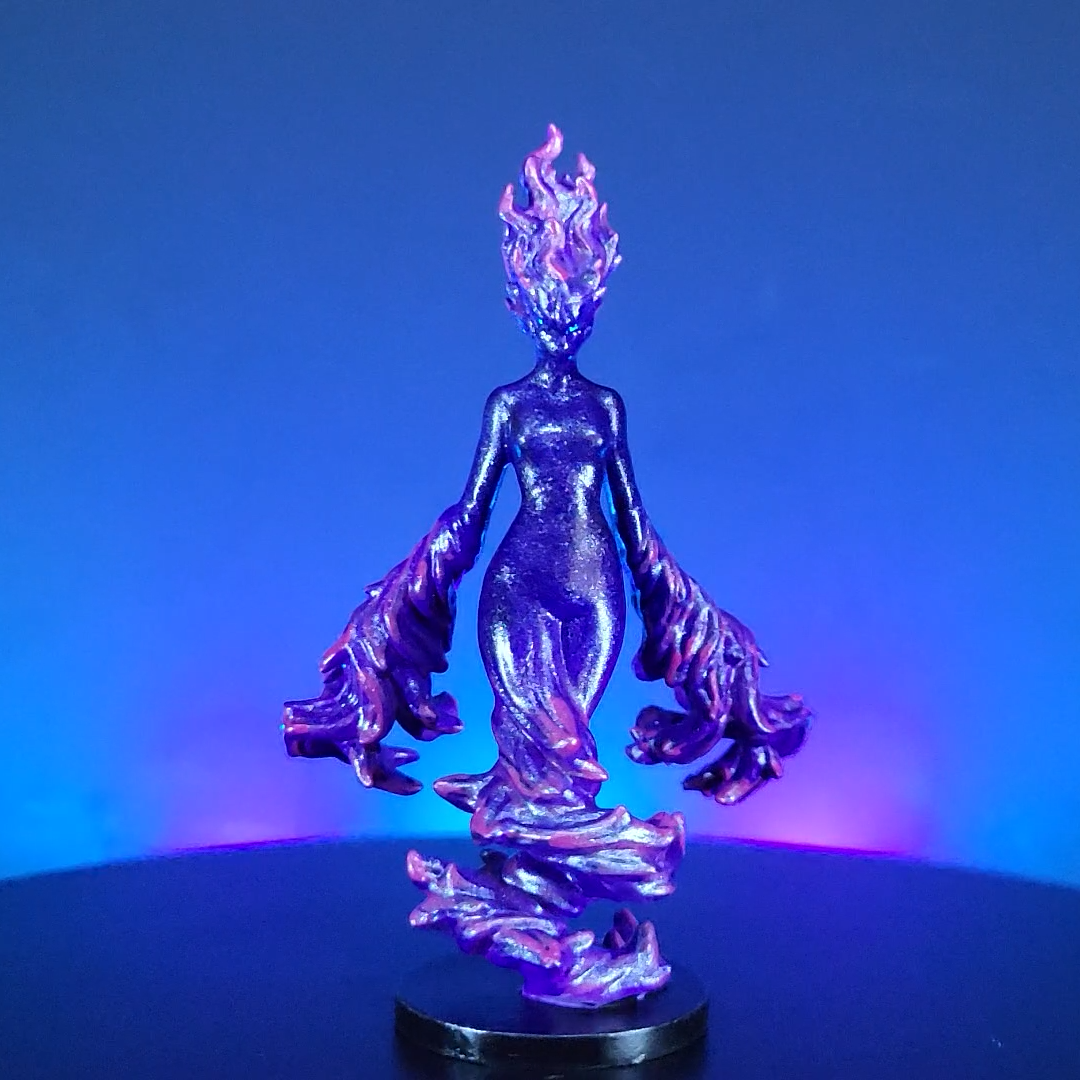 Painted Arcane Elemental miniature with glowing arcane details, photographed on a blue and purple background