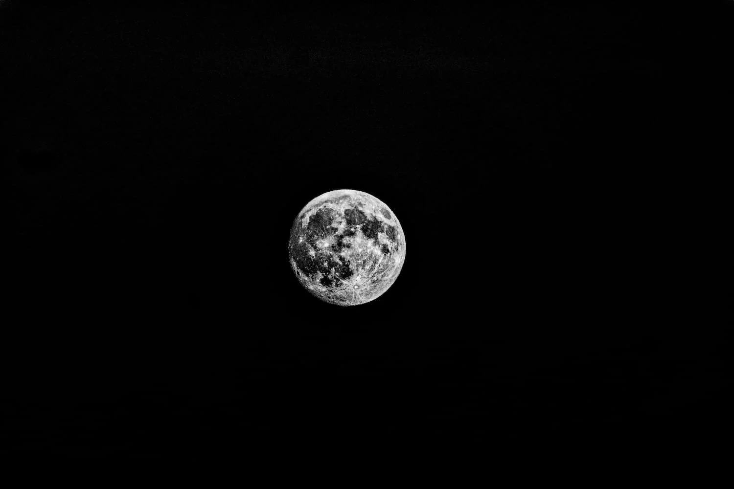 A bright full moon set against a dark night sky.