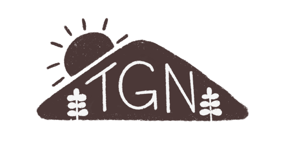 A stylized mountain with the sun rising behind it and the letters 'TGN' written on the mountain, with two small trees at the base.