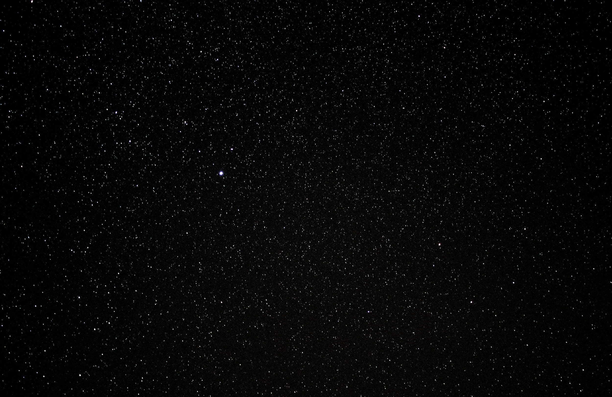 Night sky filled with numerous stars and a few celestial objects.