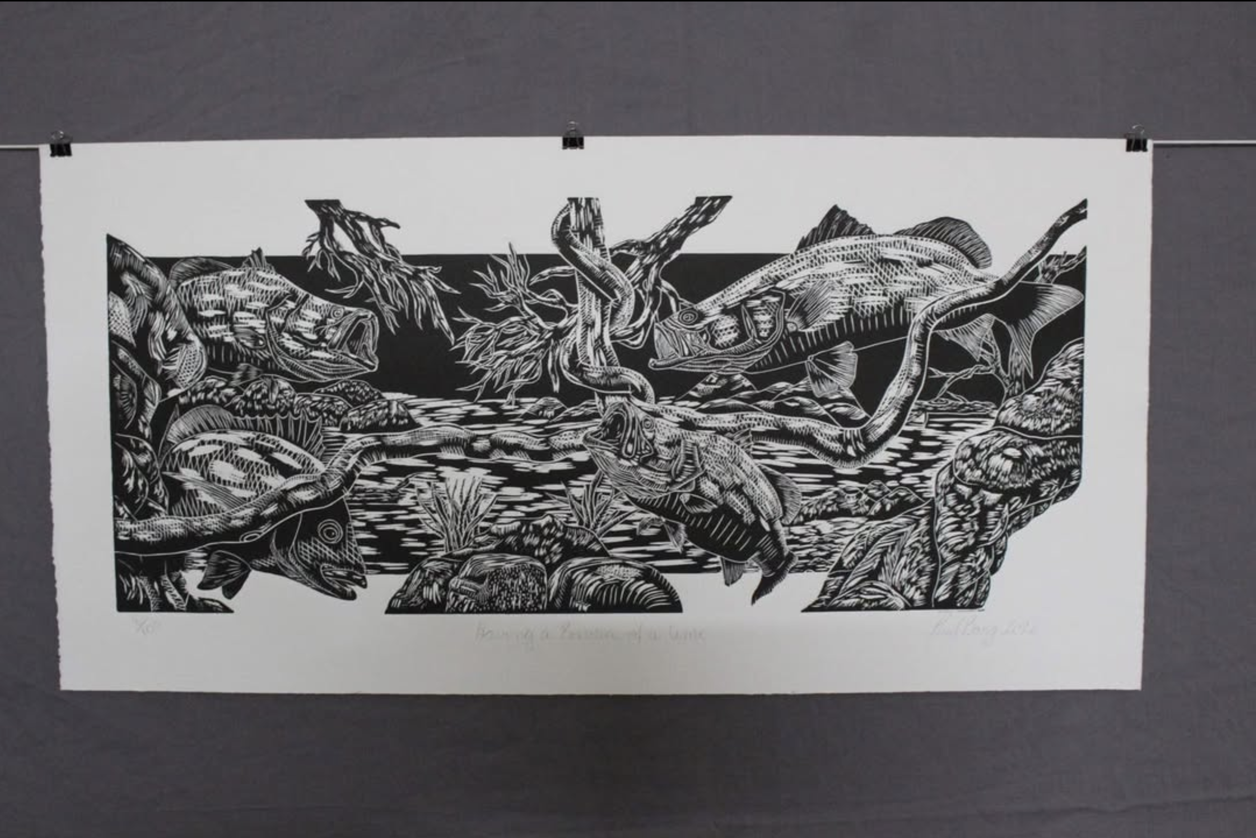 Black and white print of a nature scene with fish, frogs, and snakes near water and rocks.