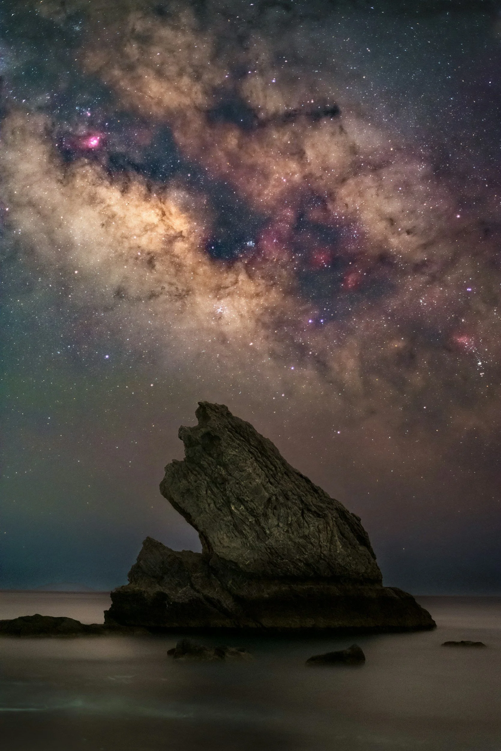 Night sky filled with stars over a desert rock formation - The Belief Studio by Pam Paul