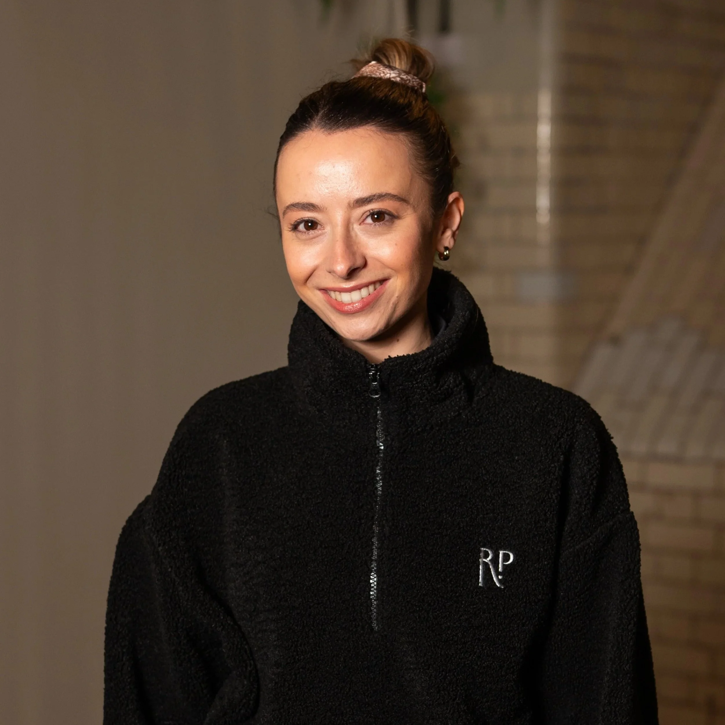 A woman with blonde hair tied up in a bobble