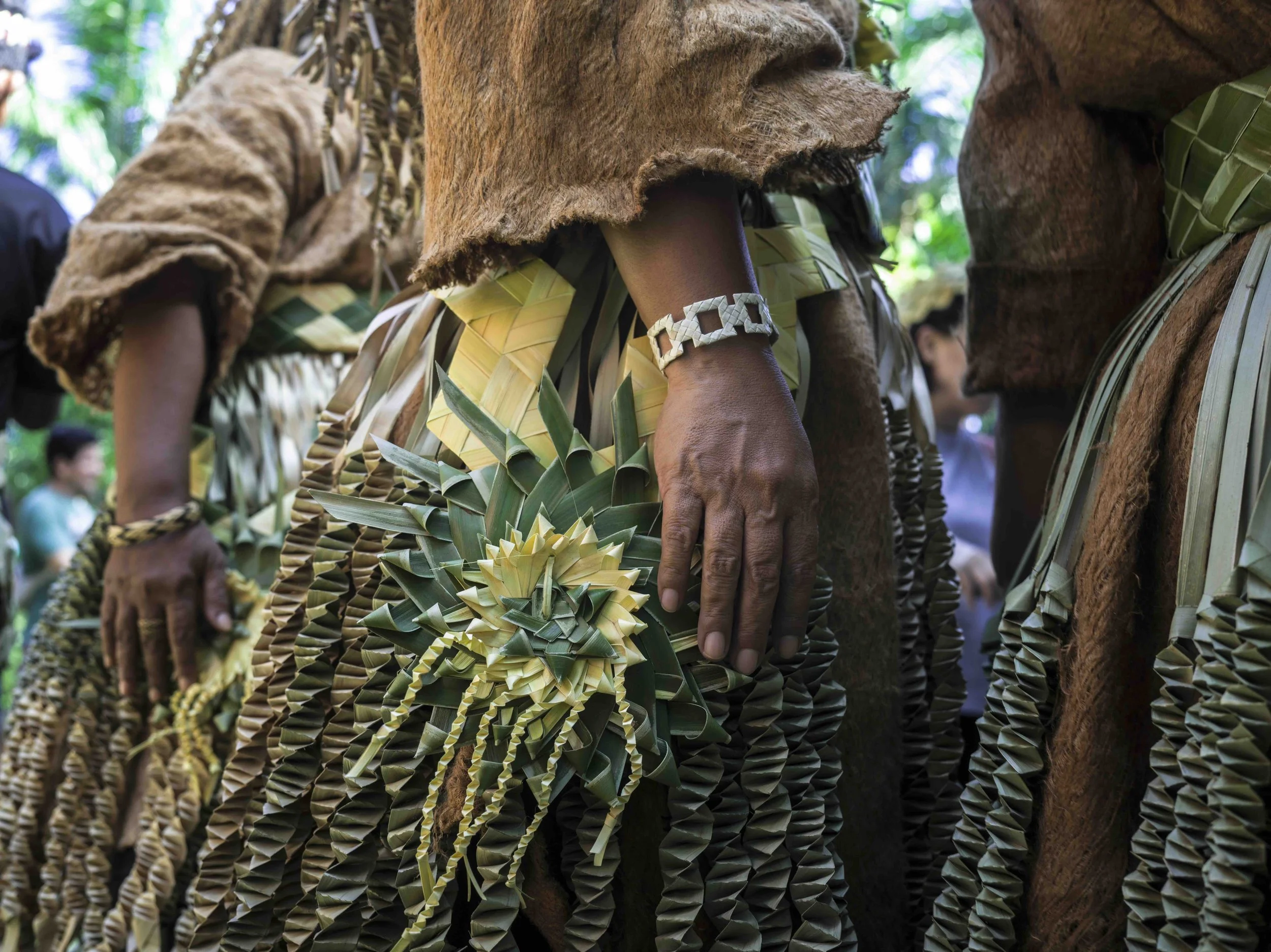 Close-up of Mah Meri wearing traditional clothing made of natural materials, with detailed woven accessories, at Hari Moyang, 2025.