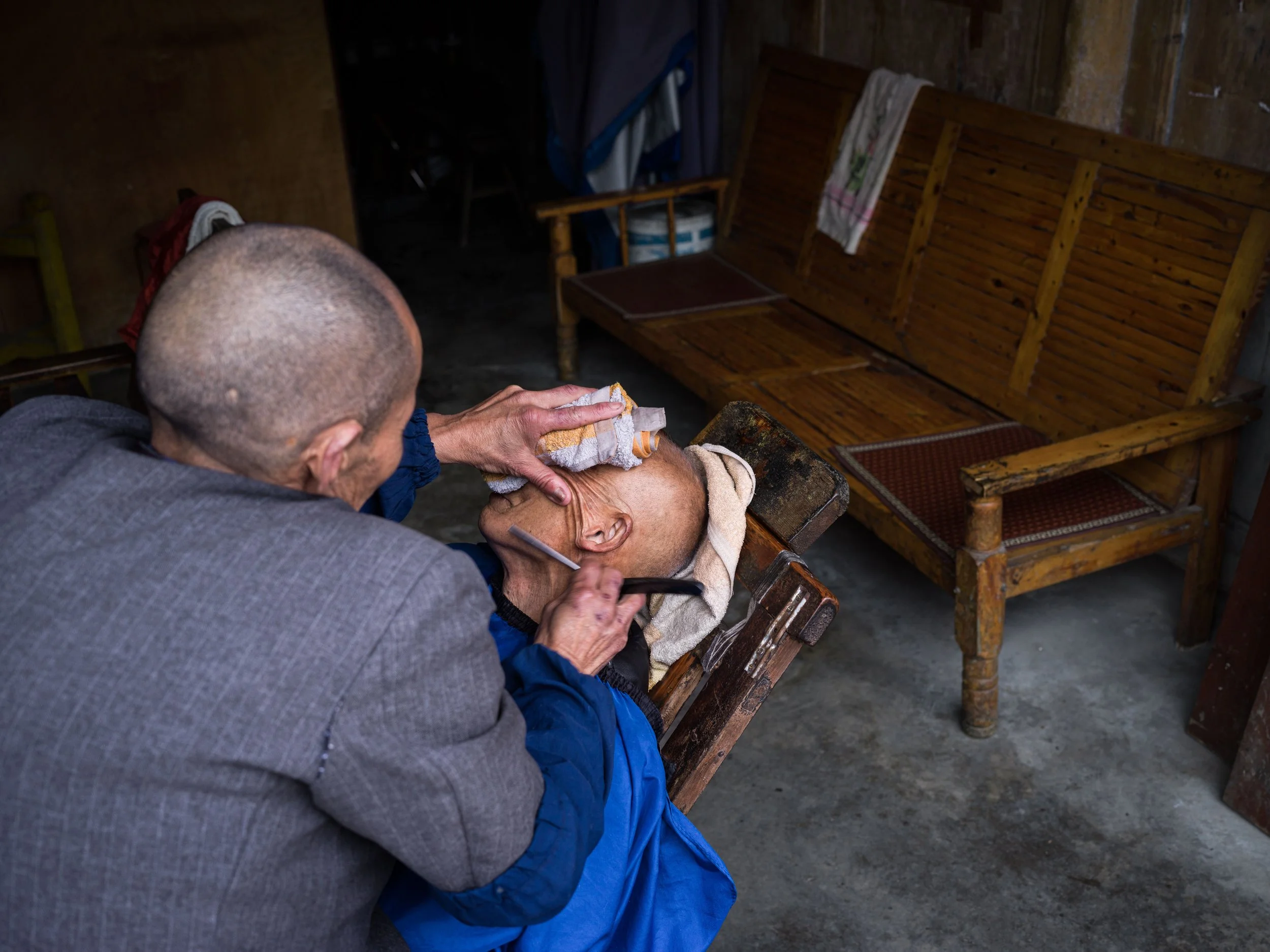 Old barber in Chengdu, China. Found in Pengzhen Old Street. 