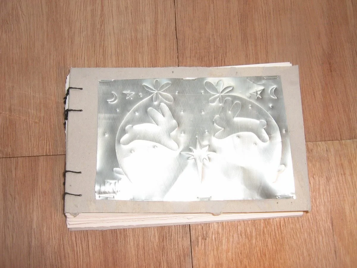 scribbles on a can and eggcarton paper photo albums