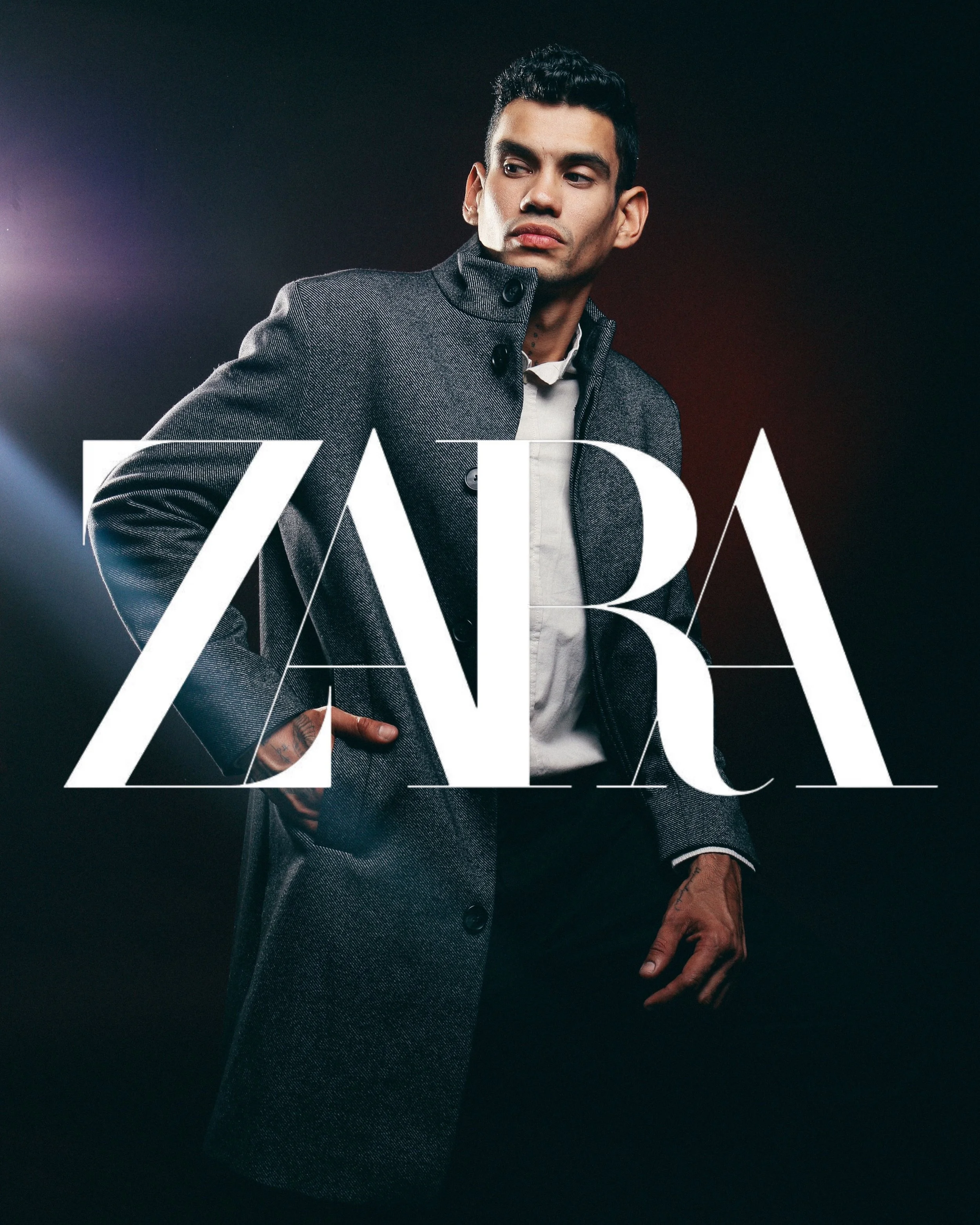 A man in a gray coat over a white shirt looks to the side against a dark background with colorful lights. The word 'ZARA' is overlaid in large white letters.