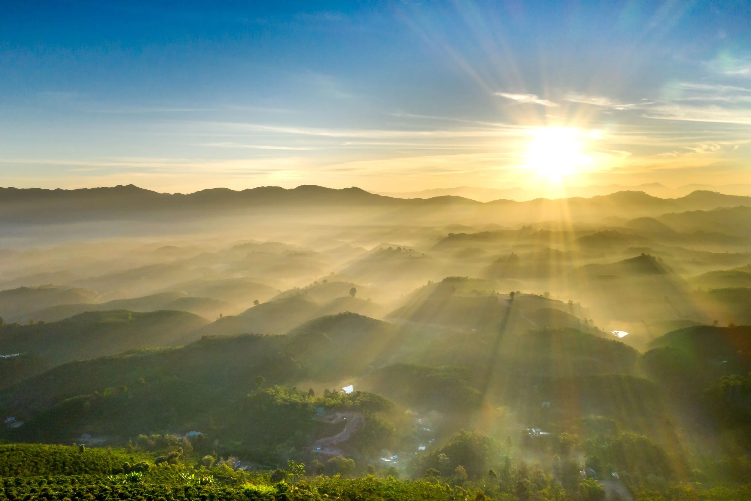 Sunrise over mist-covered mountains, representing hope and healing beyond survival mode.
