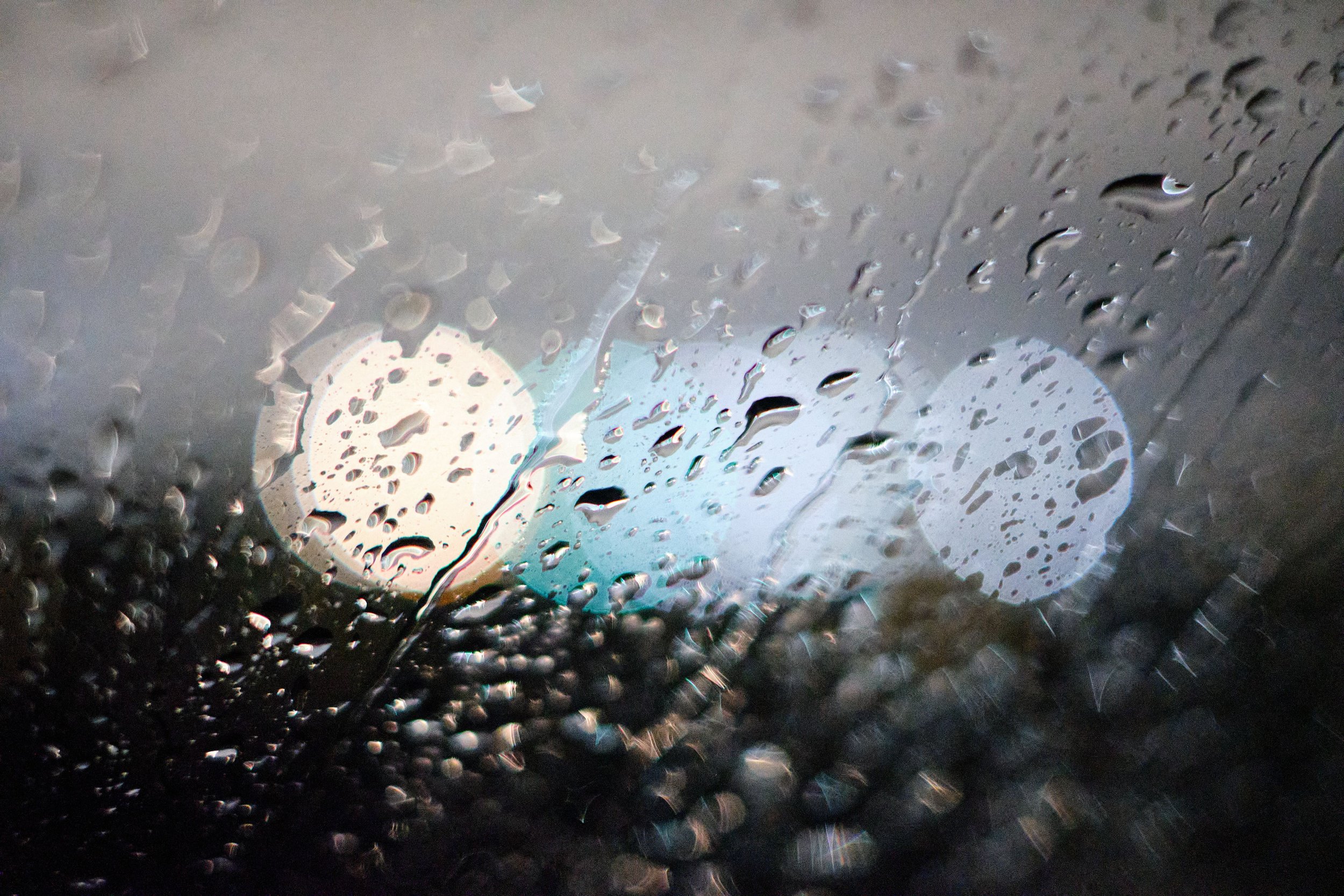 Quiet window during rainfall representing emotional numbness, difficulty crying after trauma, and reconnecting with emotions during healing.