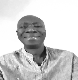 Black and white portrait of a smiling man wearing a collared shirt.
