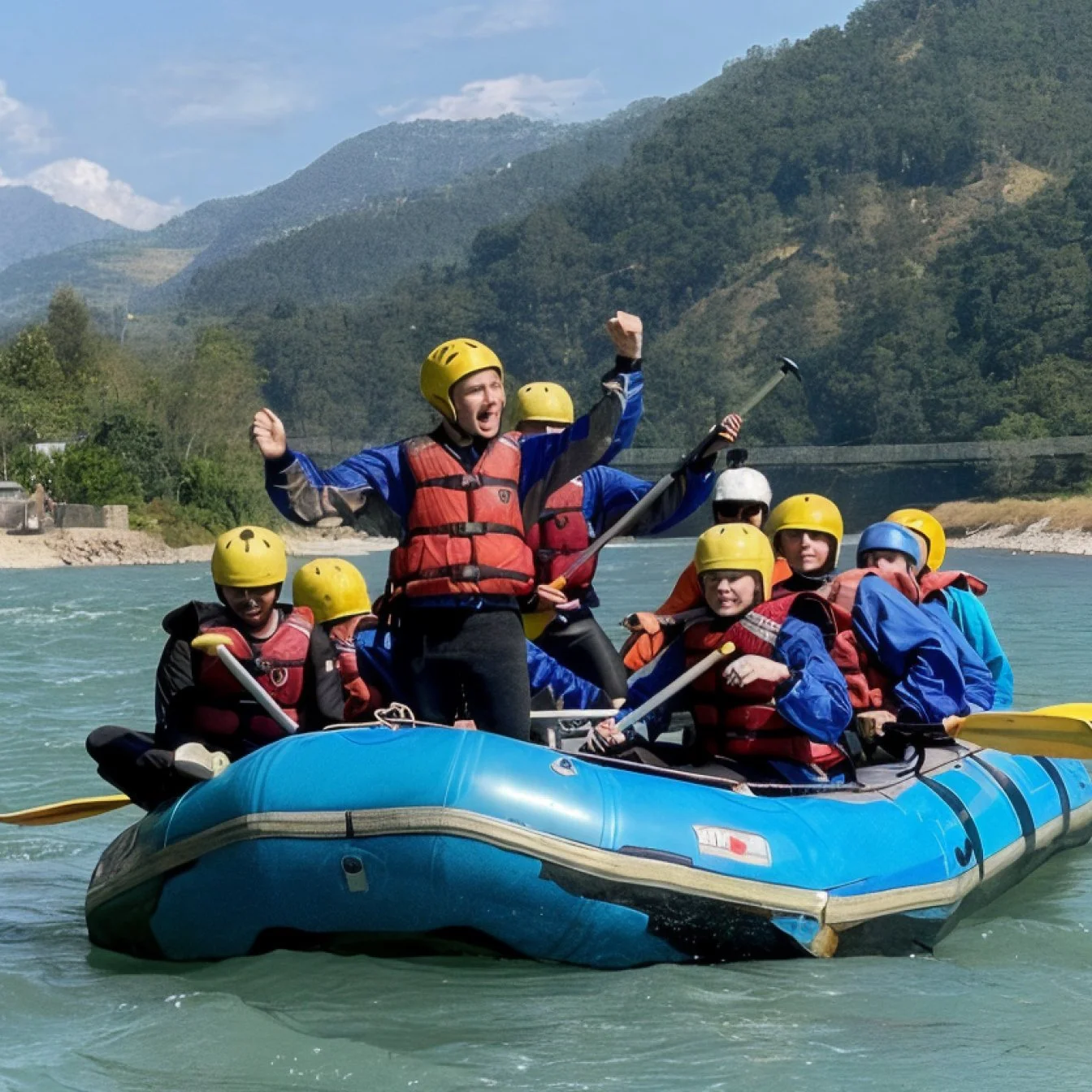 A group of people white water rafting on a river surrounded by mountains, all wearing helmets and life jackets, with one person standing and raising their arm in excitement.