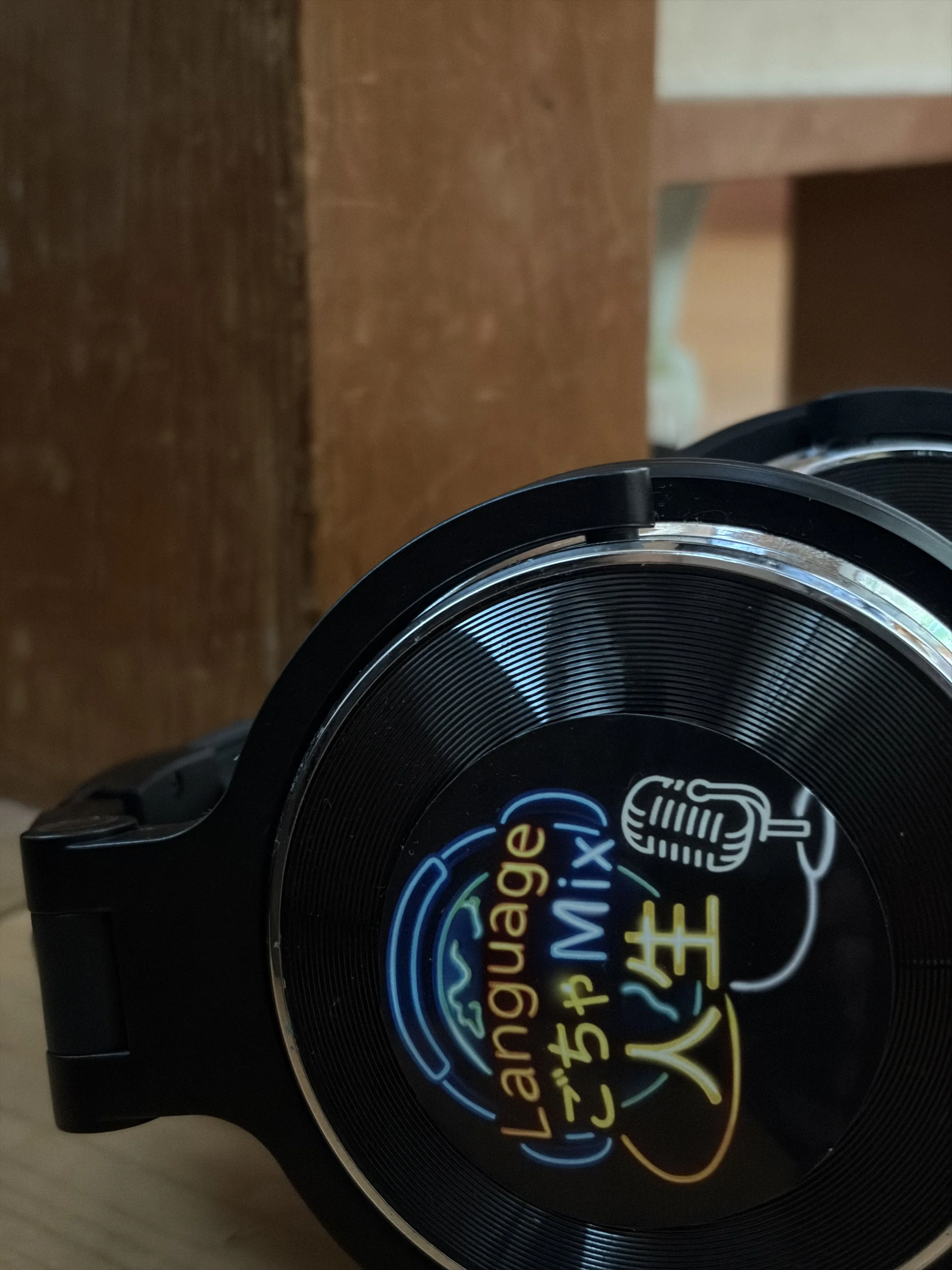 A black container of Landquage Compact Mix with neon-style Japanese and English text and a microphone illustration on the lid.