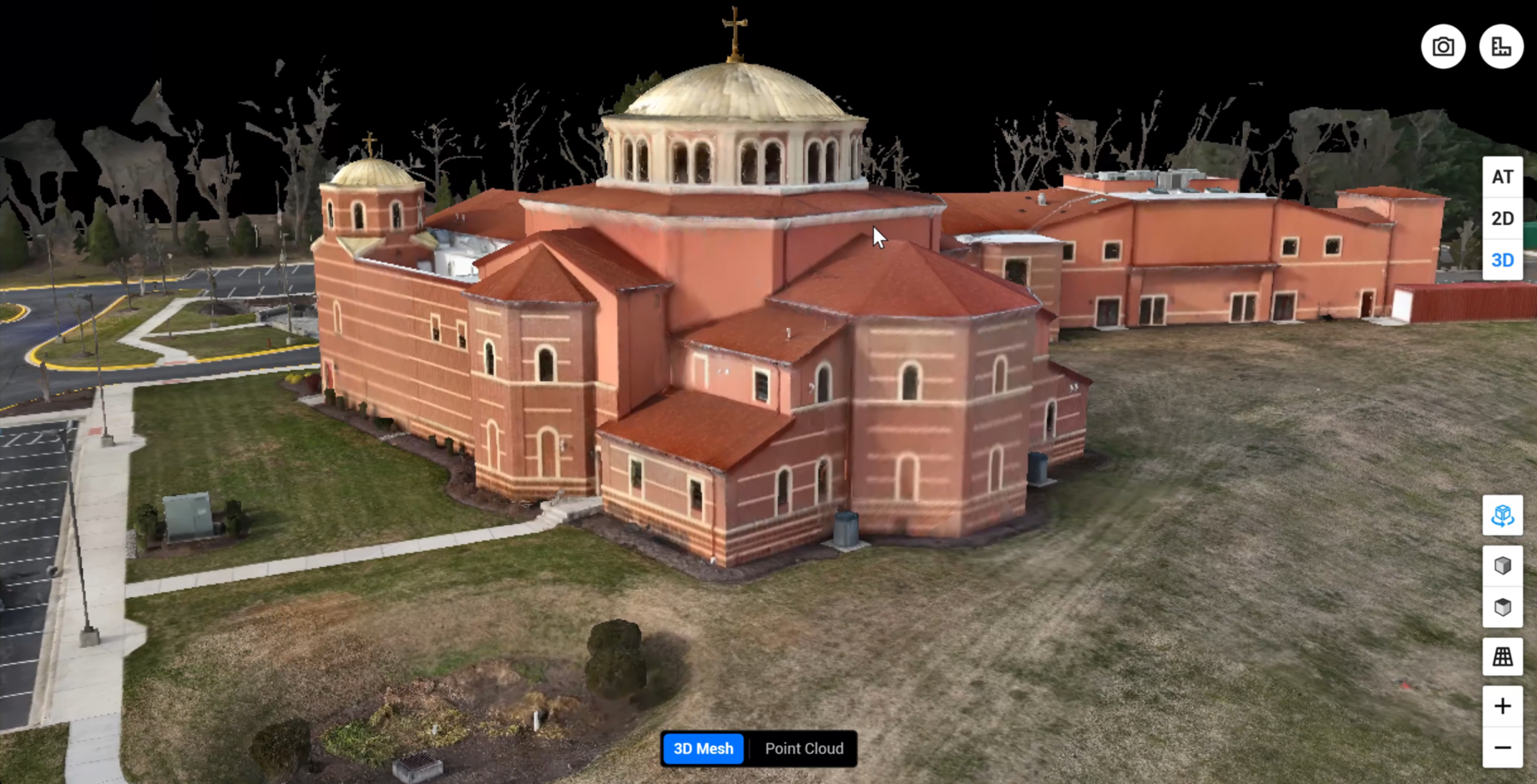 A 3D model of a large church with red brick walls, multiple roof sections, and a prominent central dome with a cross on top, surrounded by parking lot and landscaped area.