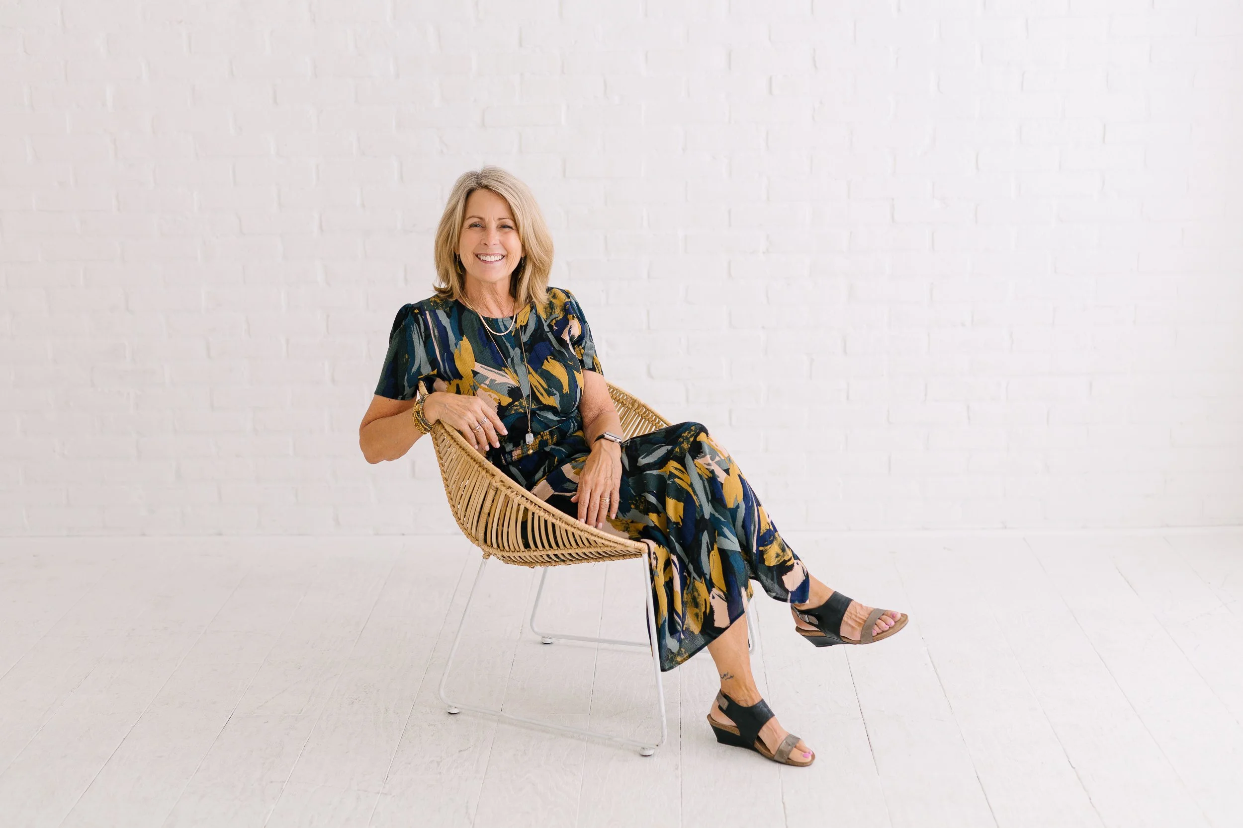 Female author smiling in a studio in downtown Boise during a branding photography session.