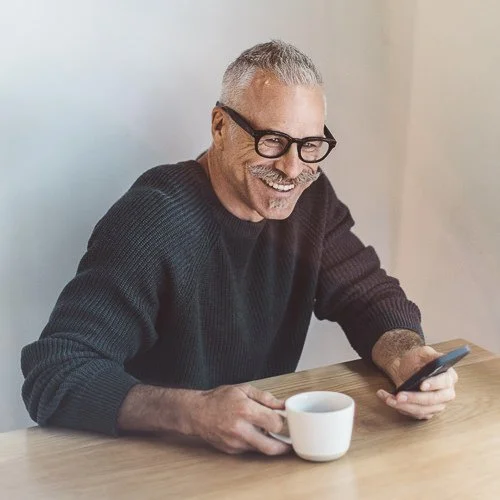 Branding photography session showing a business owner laughing in a cafe in Boise, Idaho.
