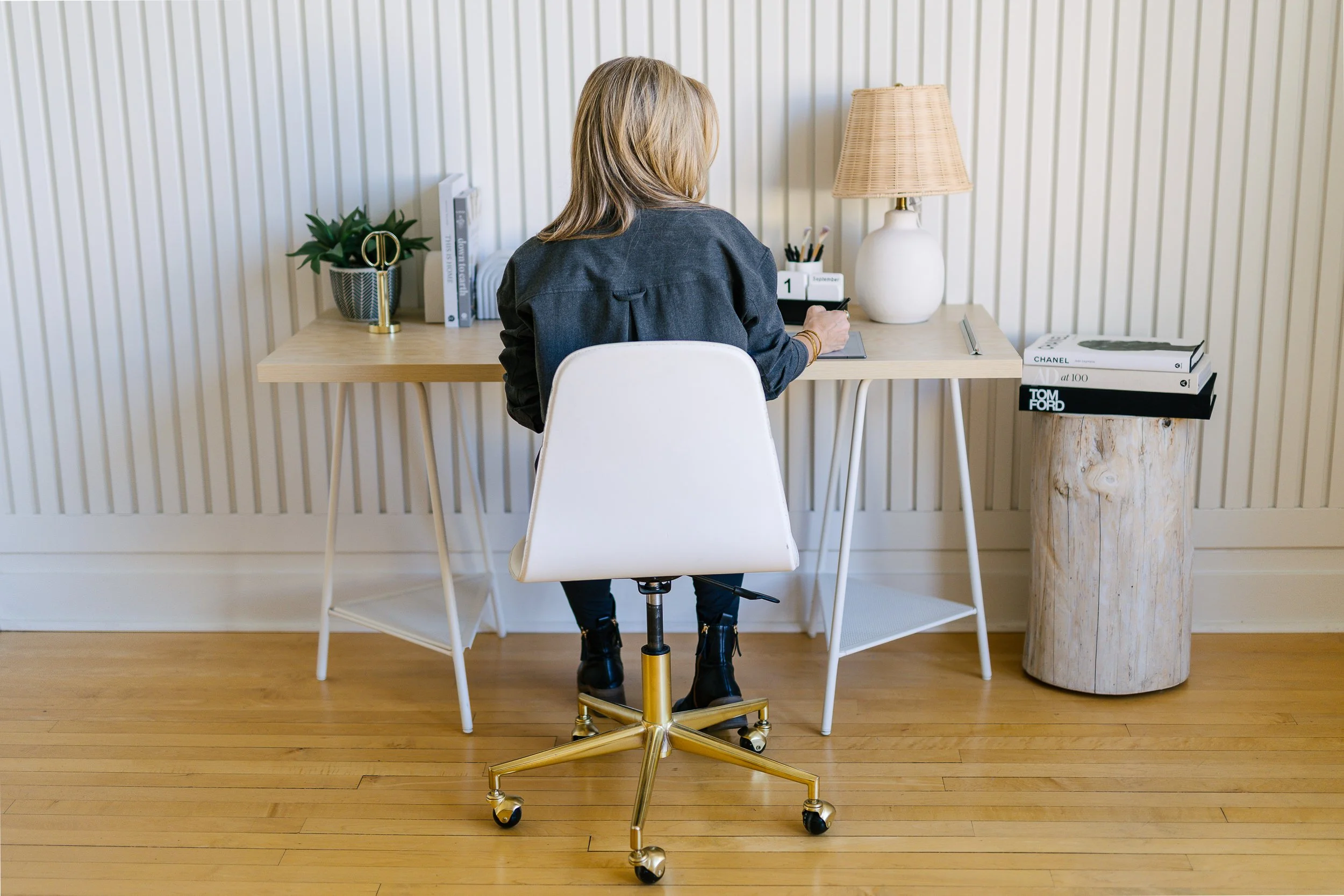 Female business owner working at a desk during a branding photoshoot in a studio in downtown Boise.