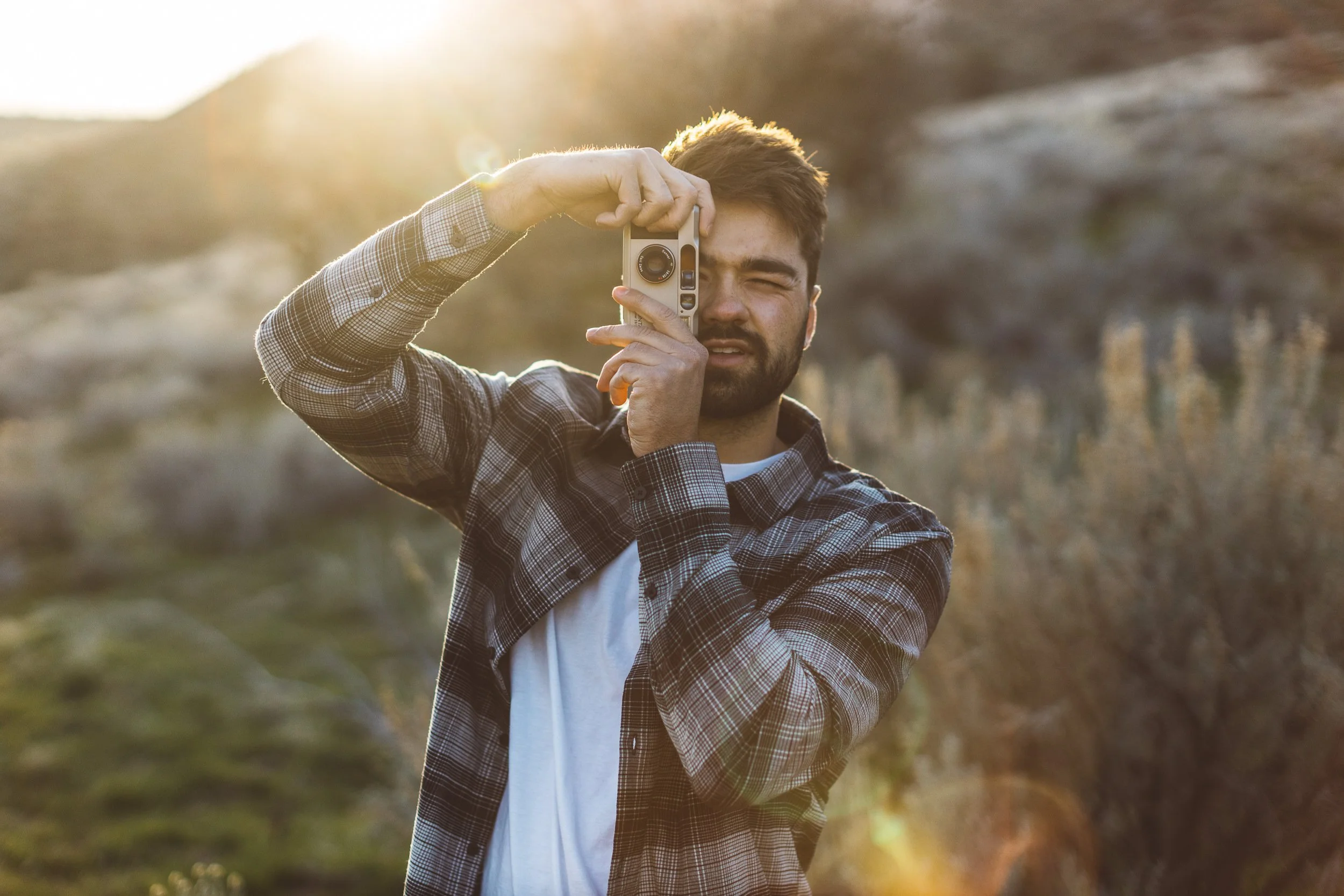 Boise branding photographer capturing lifestyle portraits of a photographer at golden hour in the Boise foothills