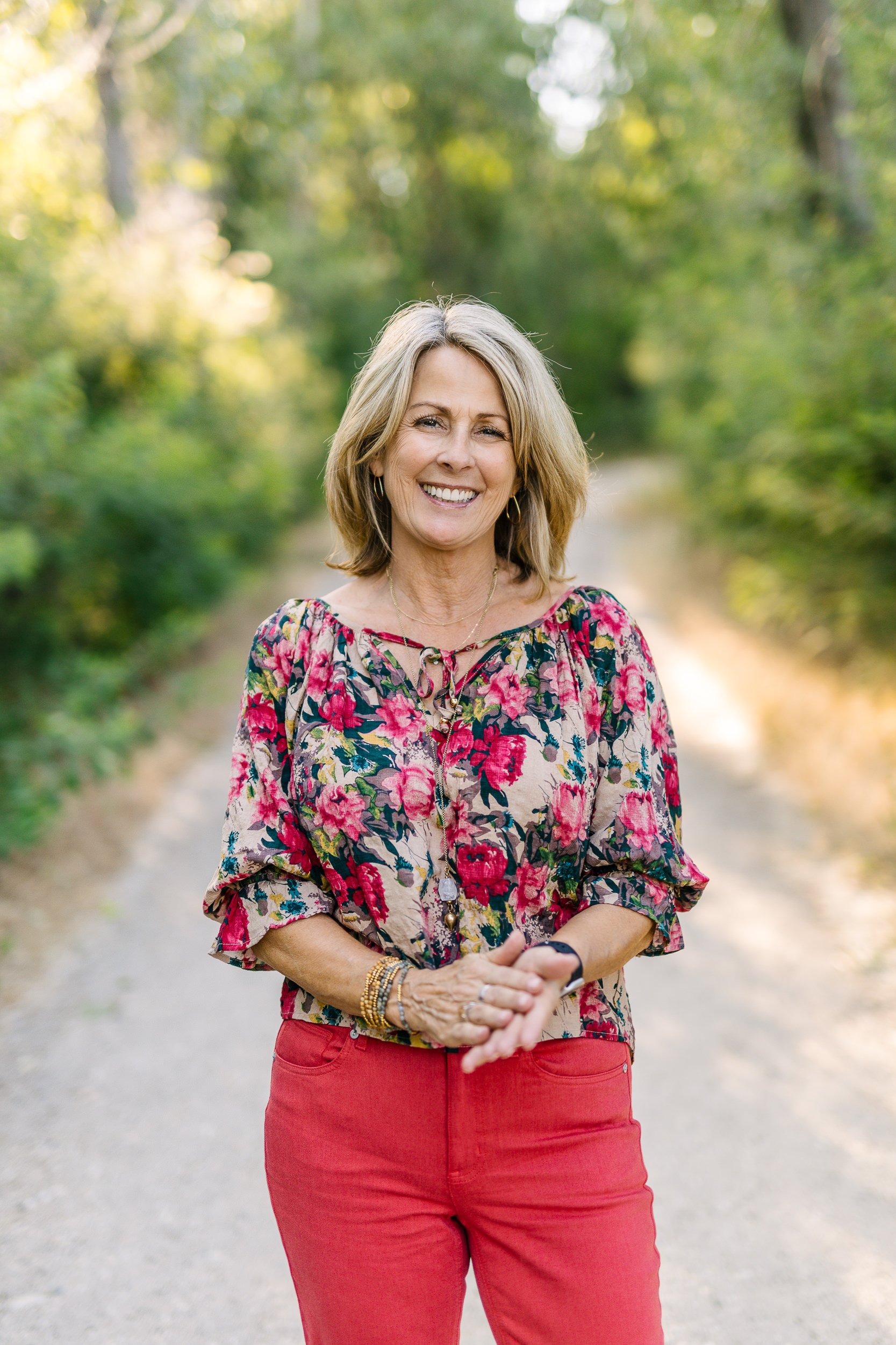 Female business owner smiling in natural light during a branding photoshoot on the boise river greenbelt.