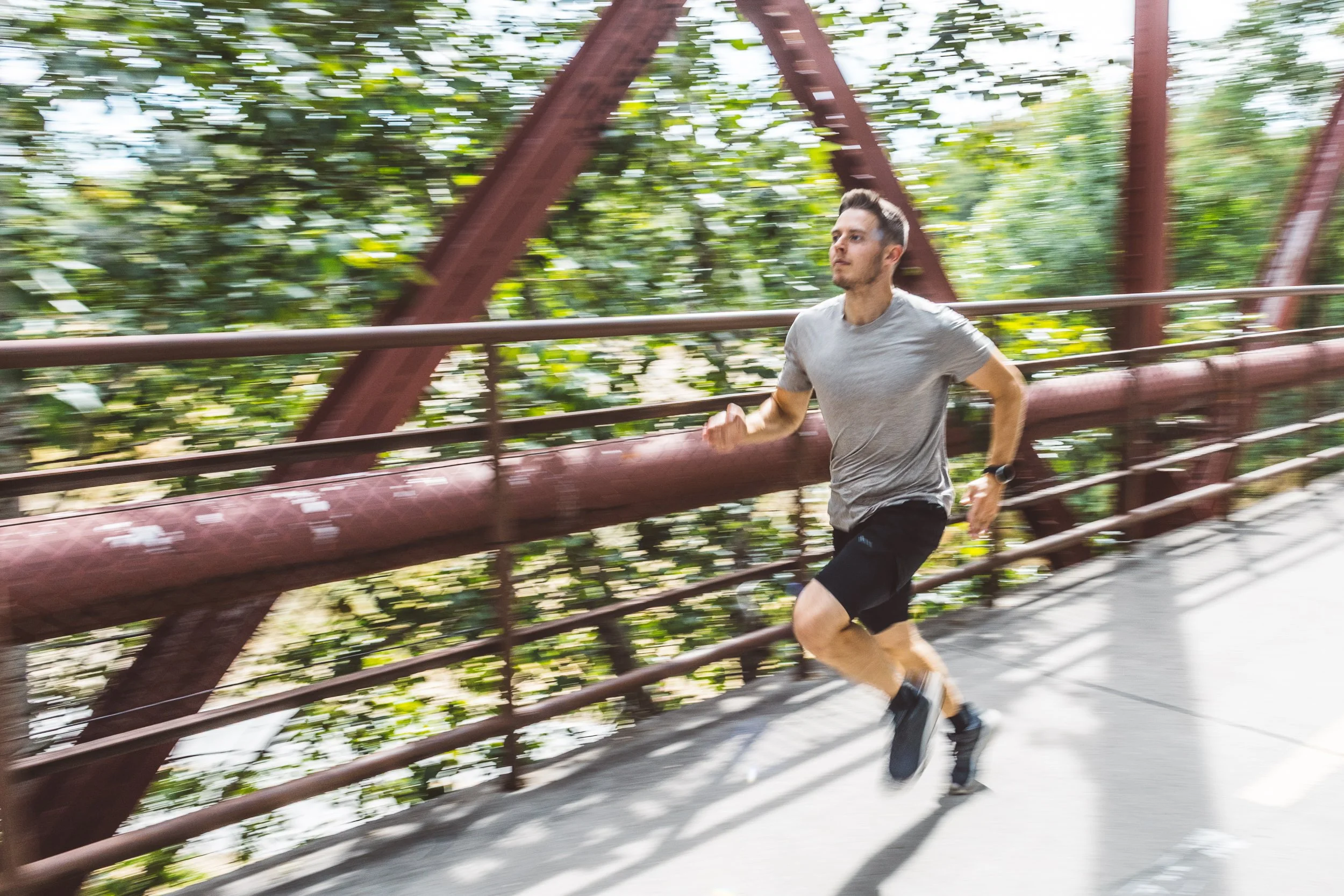 Personal branding photography of an entrepreneur running along the Boise Greenbelt during a Boise branding session focused on self-improvement