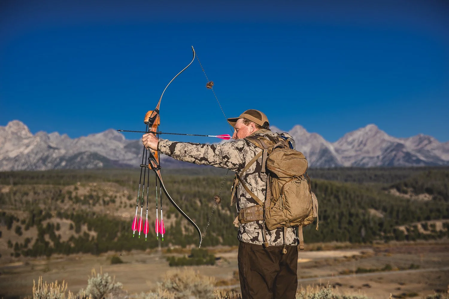 Tourism brand photography or an archery hunter in the Sawtooth Mountains for Idaho destination marketing