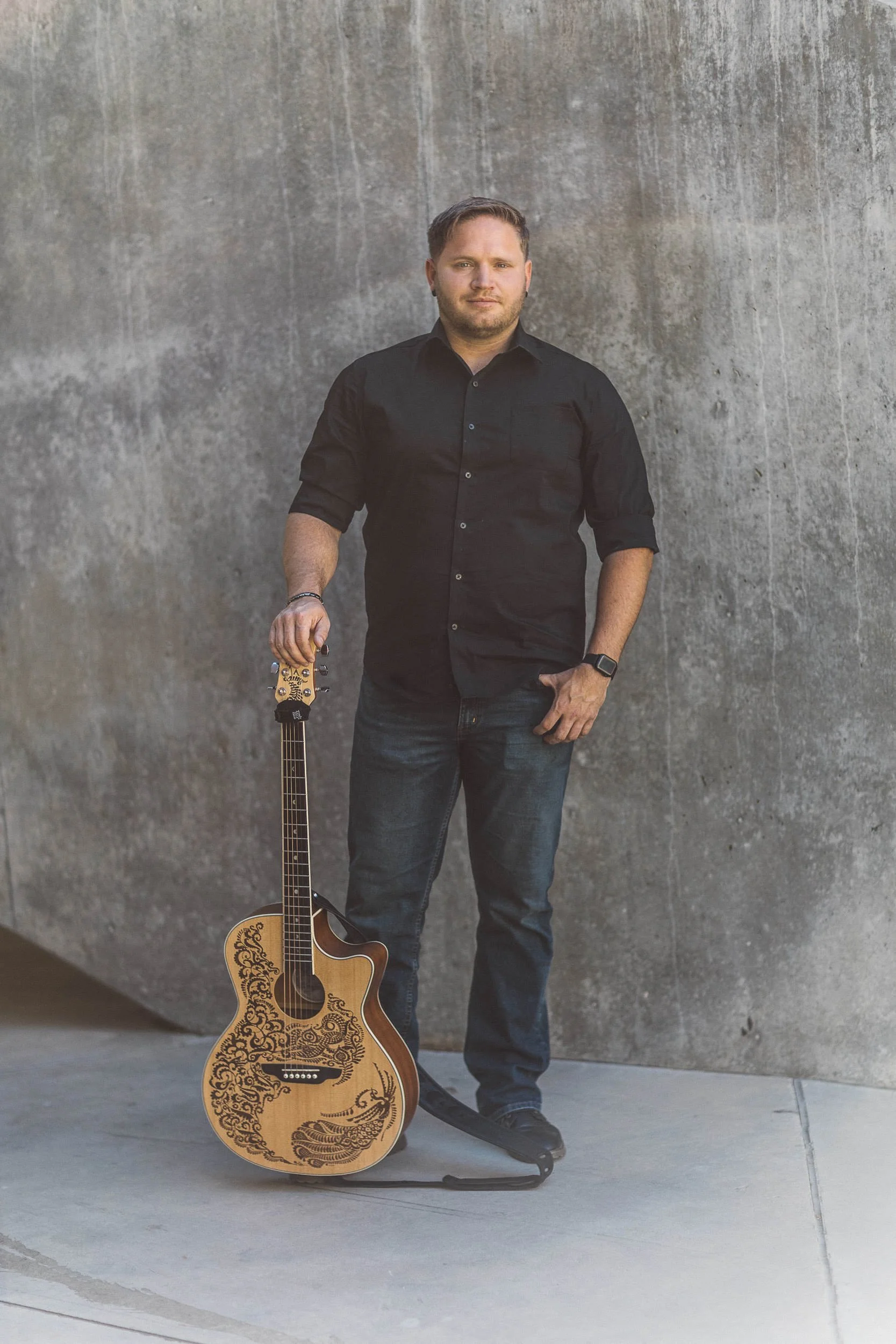 Musician looking at camera seriously during a branding photography session in Downtown Boise.