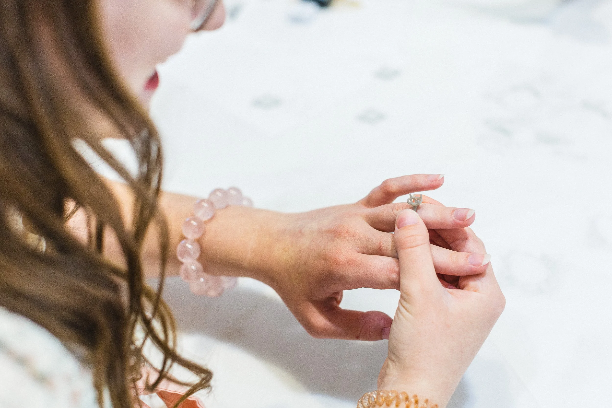 Lifestyle branding photo of a woman trying on a ring in a custom jewelry shop during a branding photoshoot in downtown Boise.