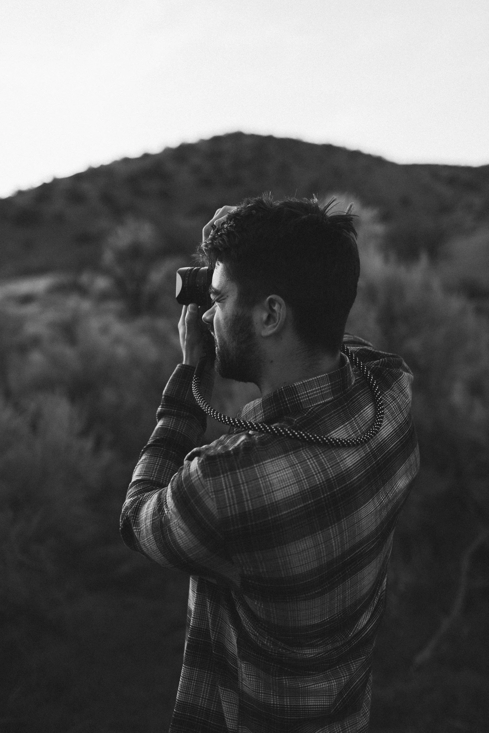 Boise photographer taking photos in the boise foothills during a branding photo session at sunset.