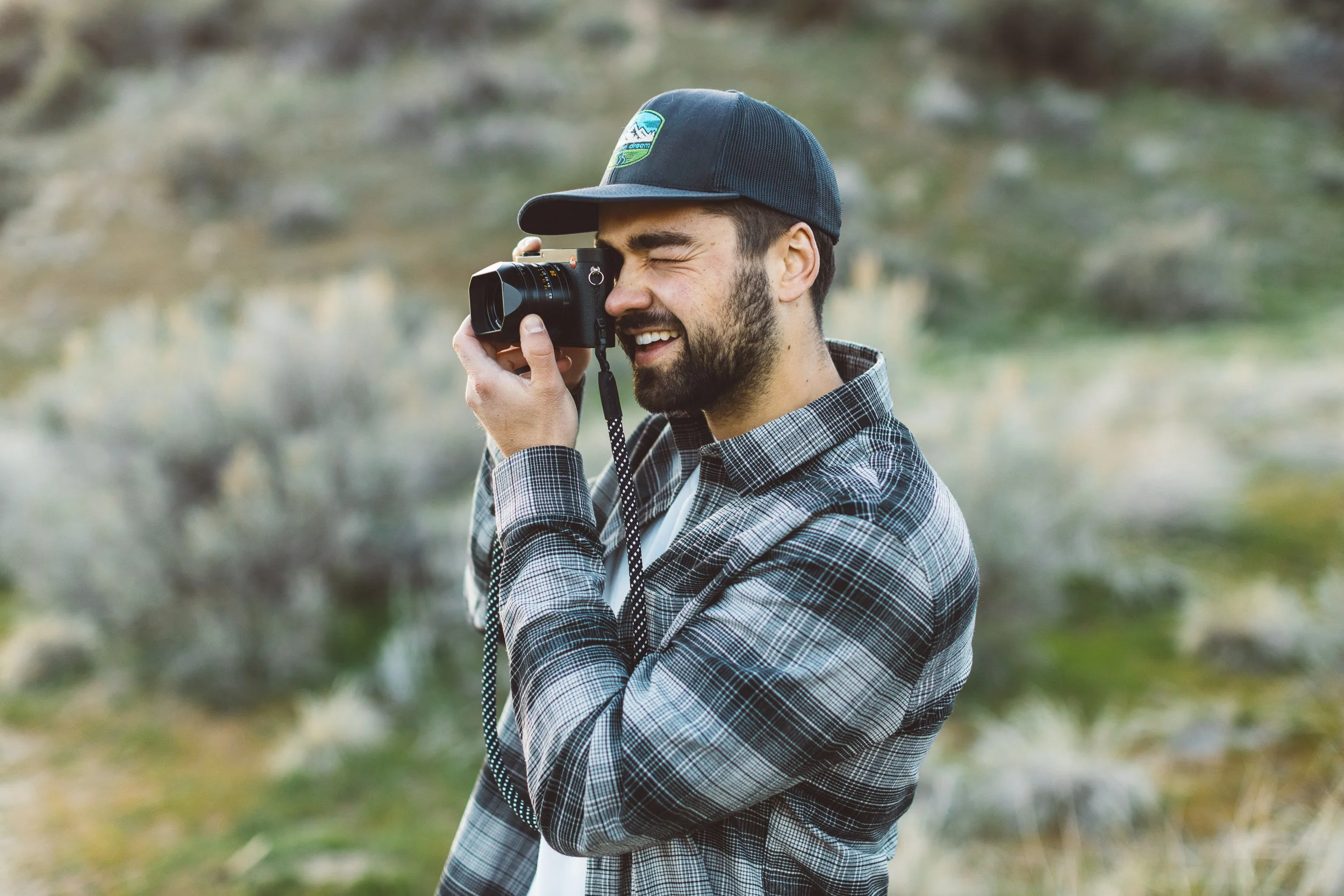 Photographer taking a photo in the Boise Foothills during a personal branding photo session.