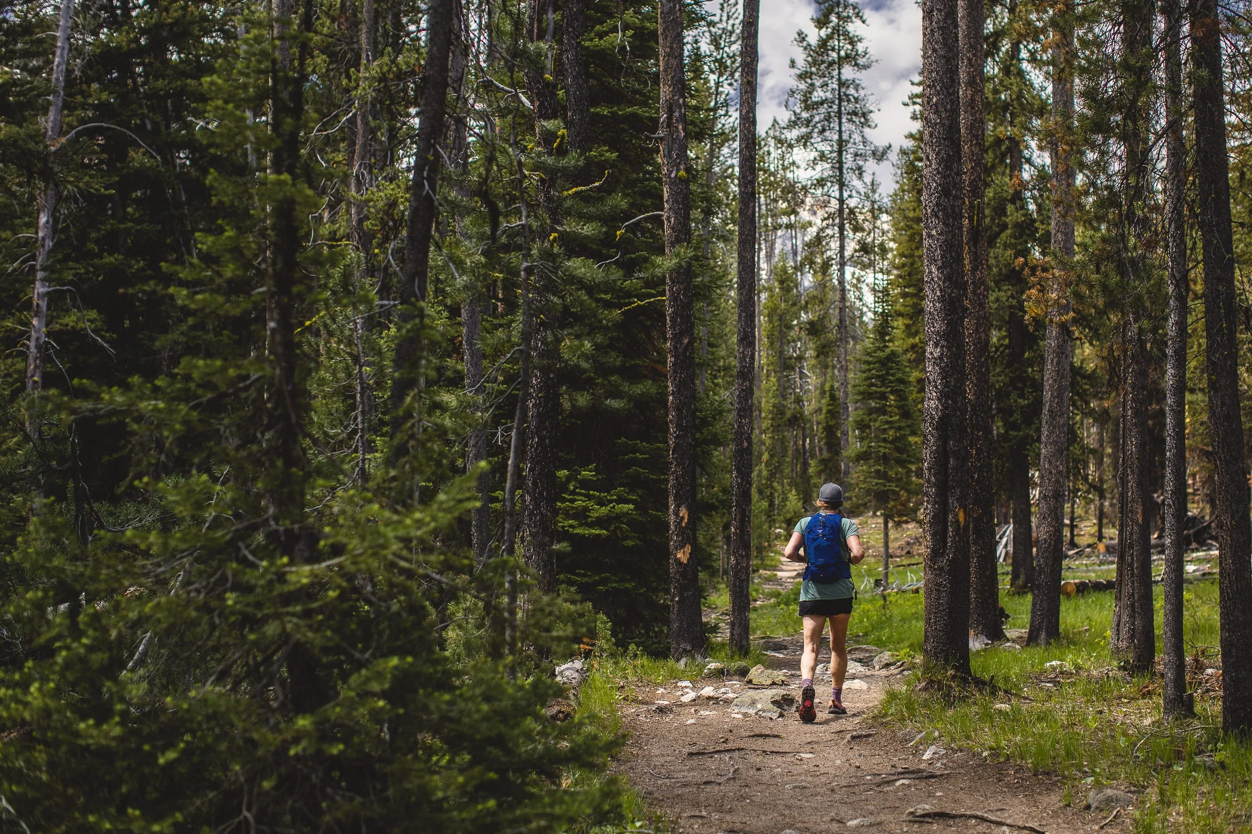 Woman hiking at iron creek in Stanley Idaho during an adventure branding photoshoot.