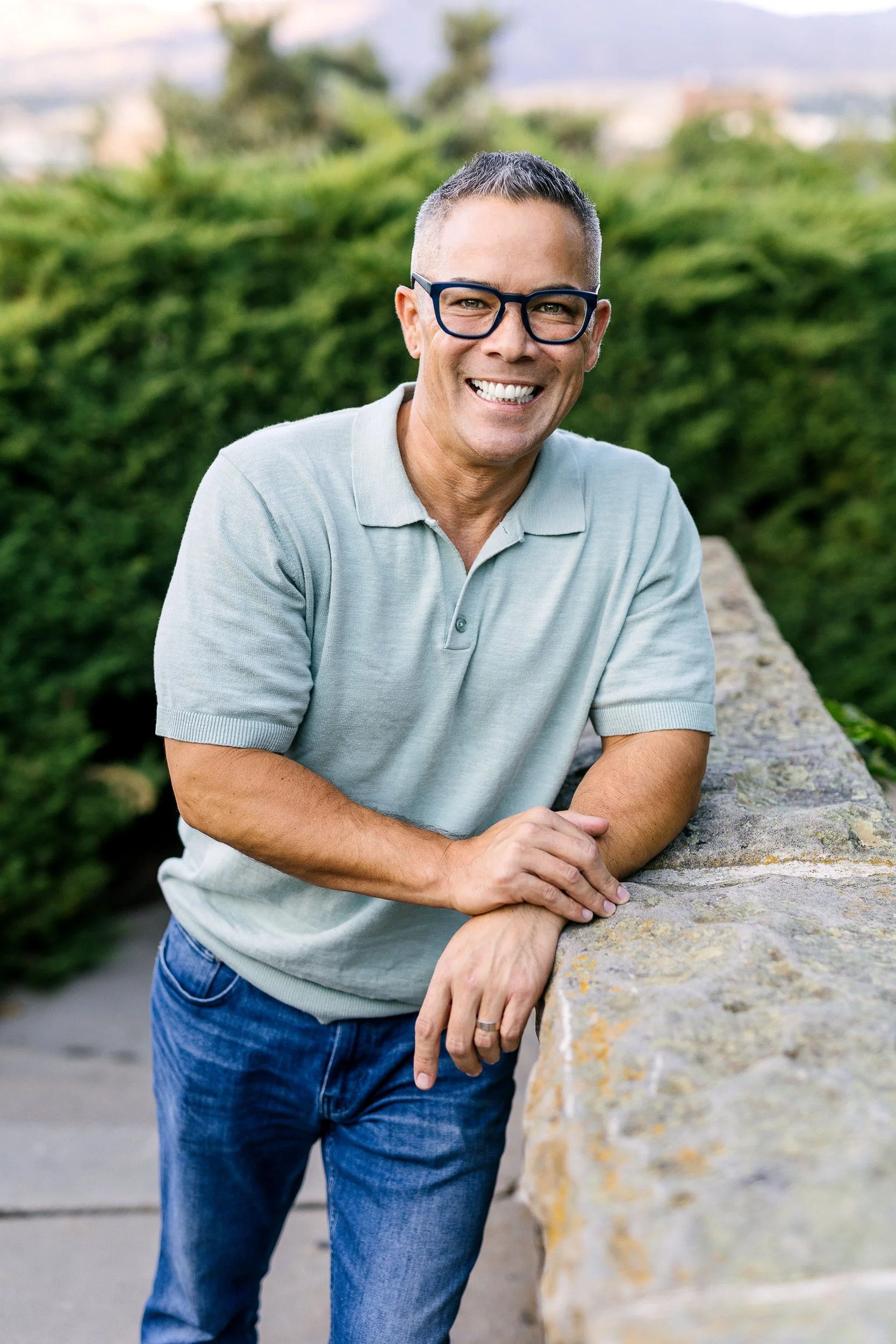 Mortgage Broker Ryan Namba looking at the camera smiling during a branding photography session at the Boise Train Depot.