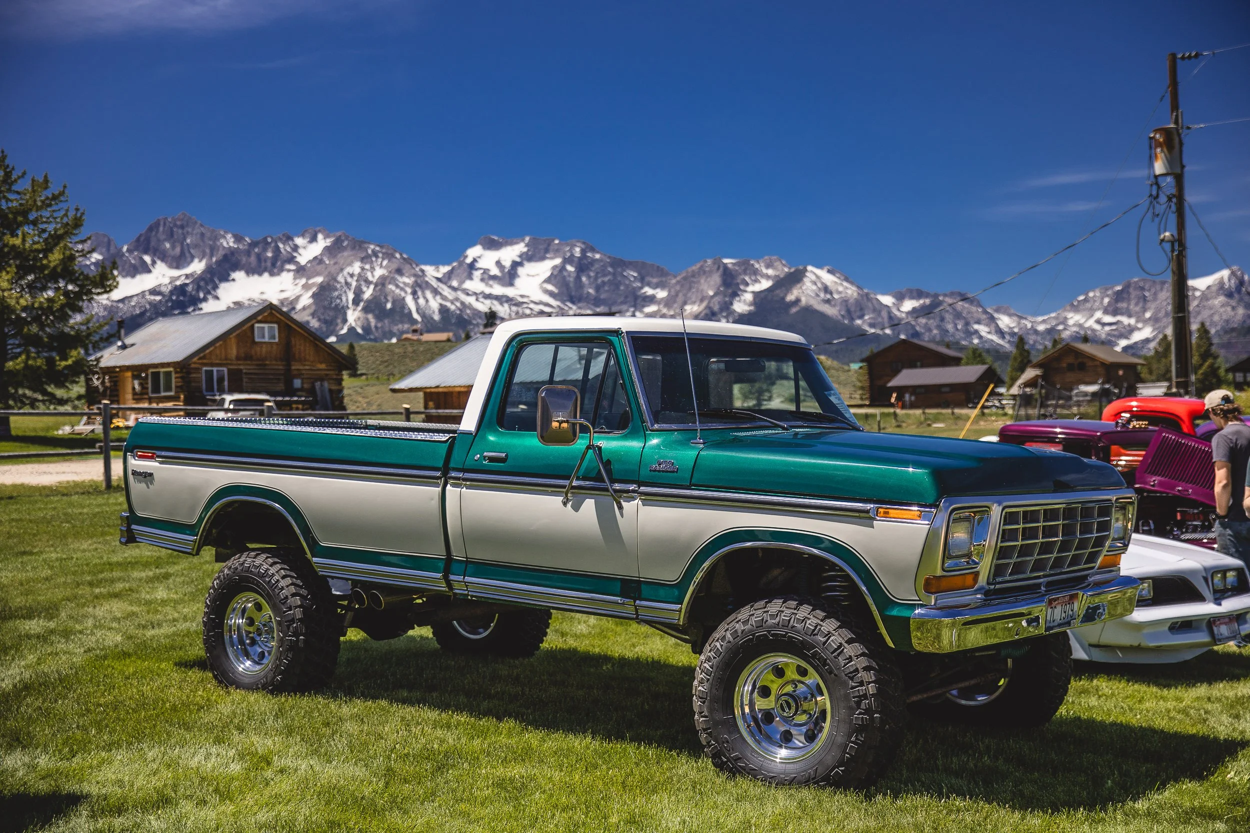 Photo of an old ford pickup at a car show at the base of the Sawtooth Mountains during a branding photoshoot in Stanley Idaho.