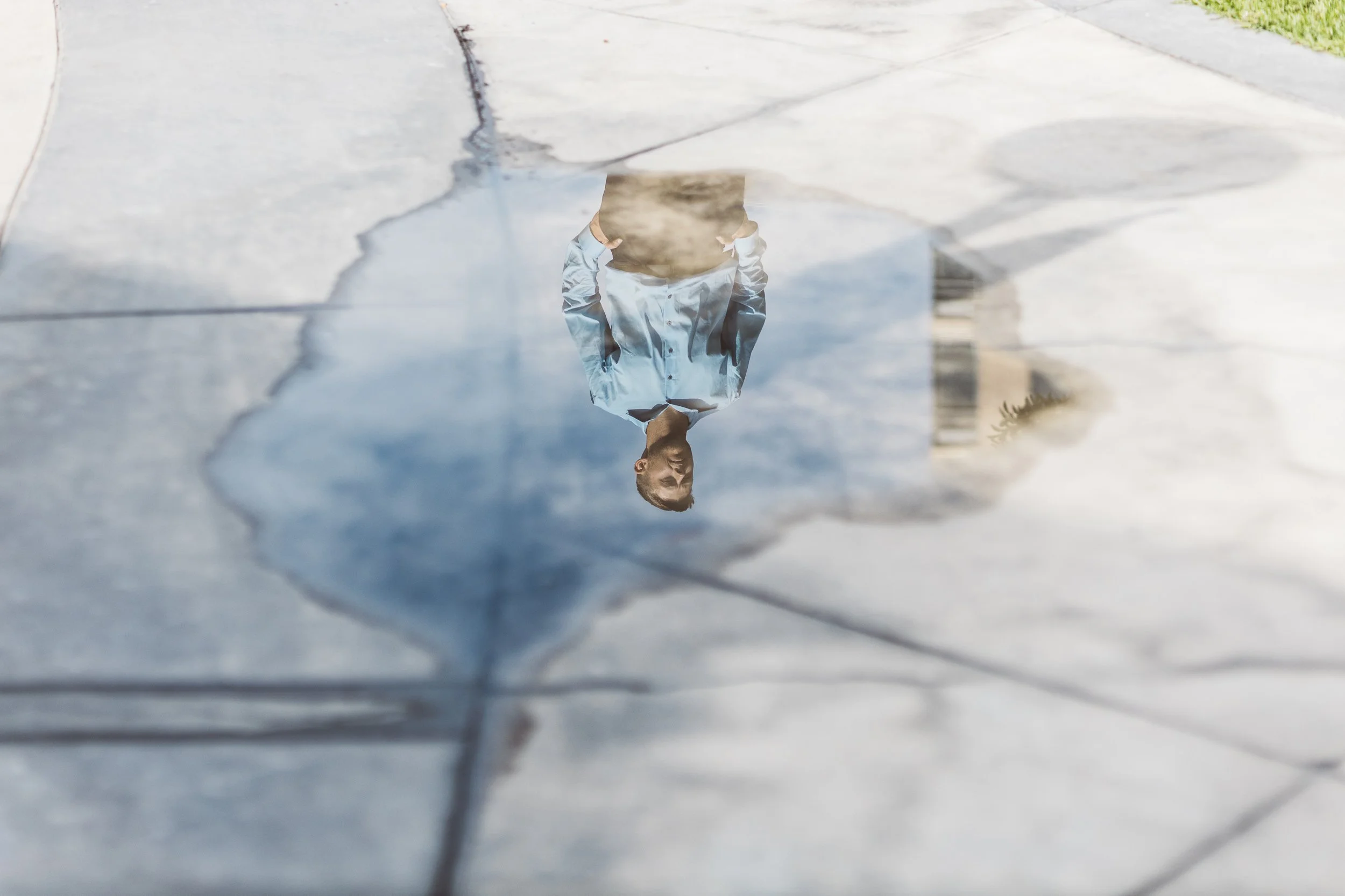 High-energy personal branding photography at Jump Boise featuring a Boise entrepreneur reflected in a puddle during a full-day branding photoshoot