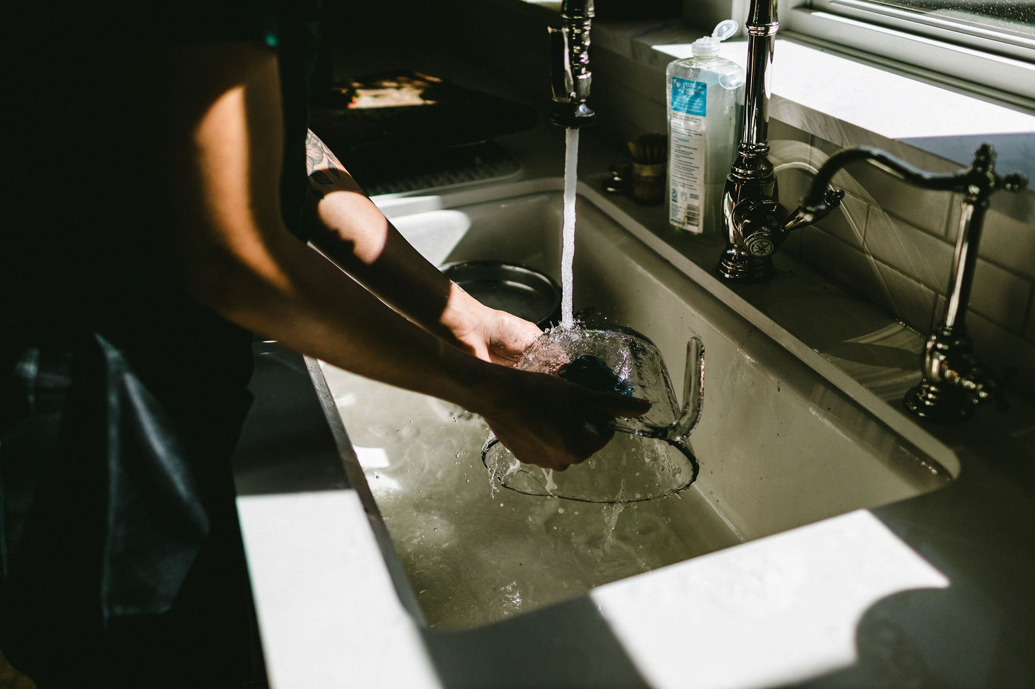 Branding photo of a woman's hands washing dishes during a branding photography session in Boise, Idaho.