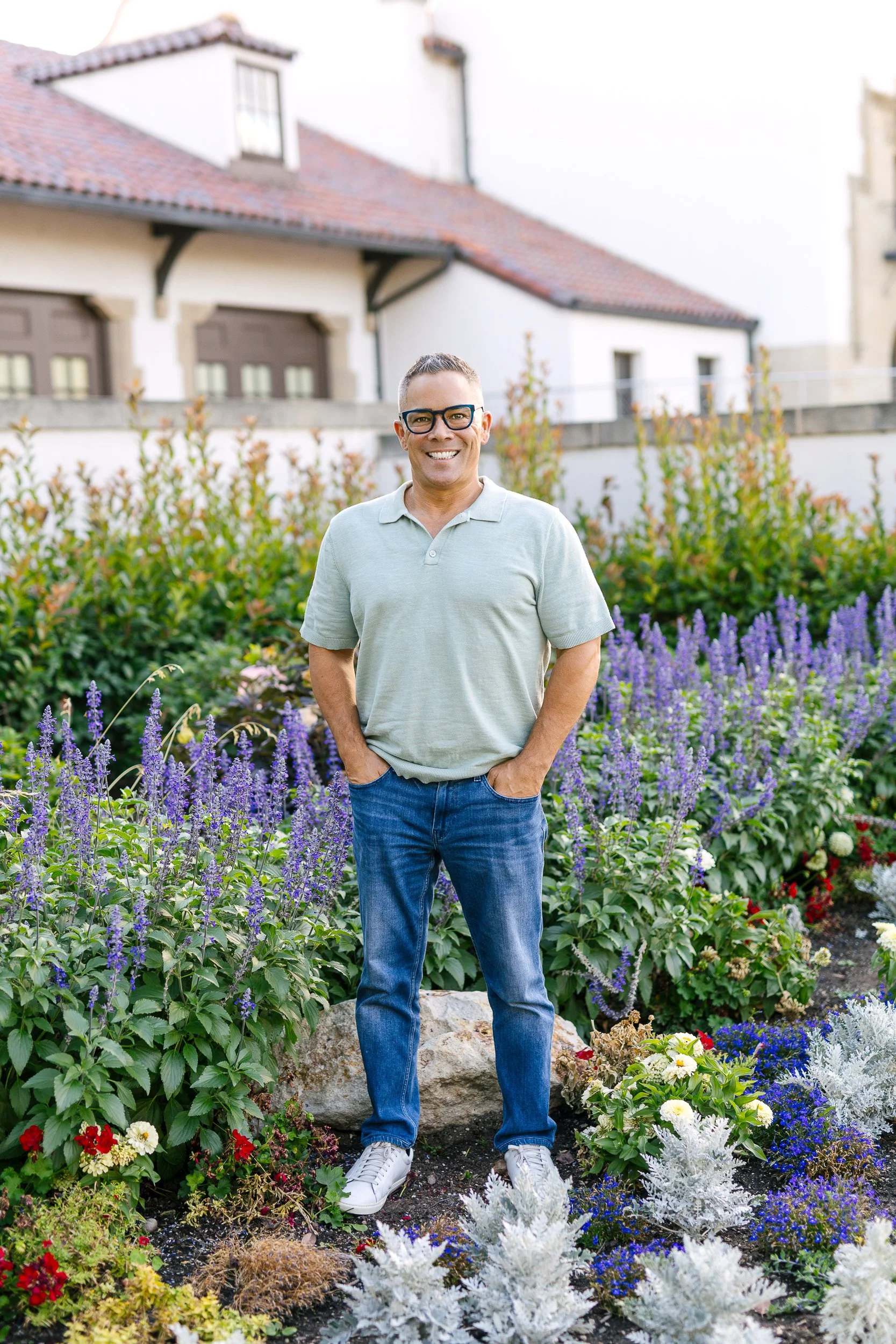 Male business owner smiling while looking at the camera during a branding photoshoot at the Boise Train Depot.