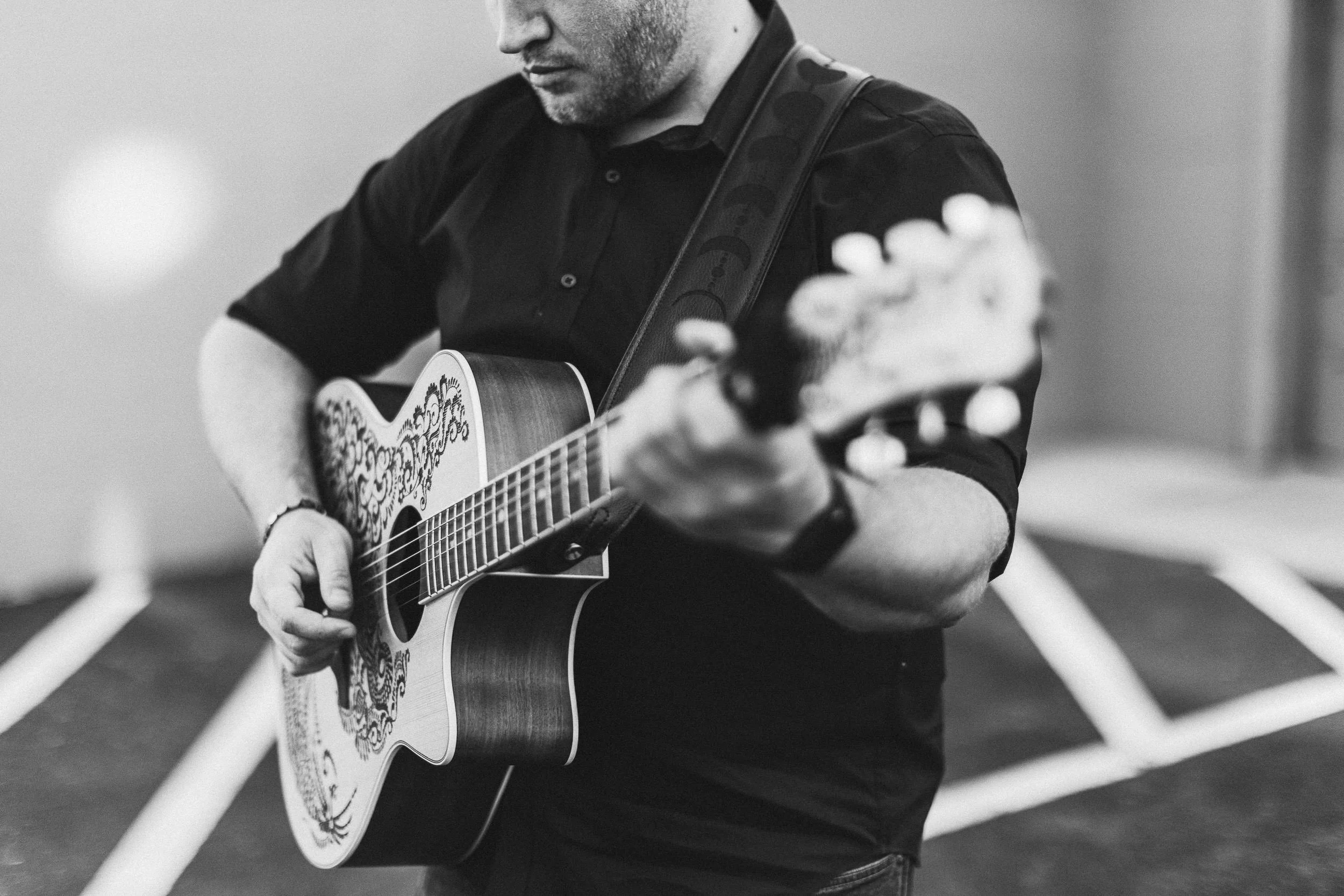 Musicician playing a guitar during a branding photoshoot at Jump in Downtown Boise.