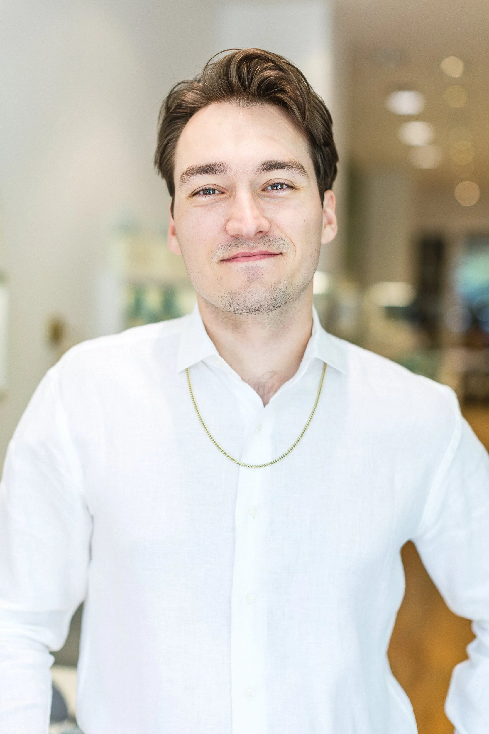 Lifestyle branding photo of a male business owner smiling in a custom jewelry shop during a branding photoshoot in downtown Boise.