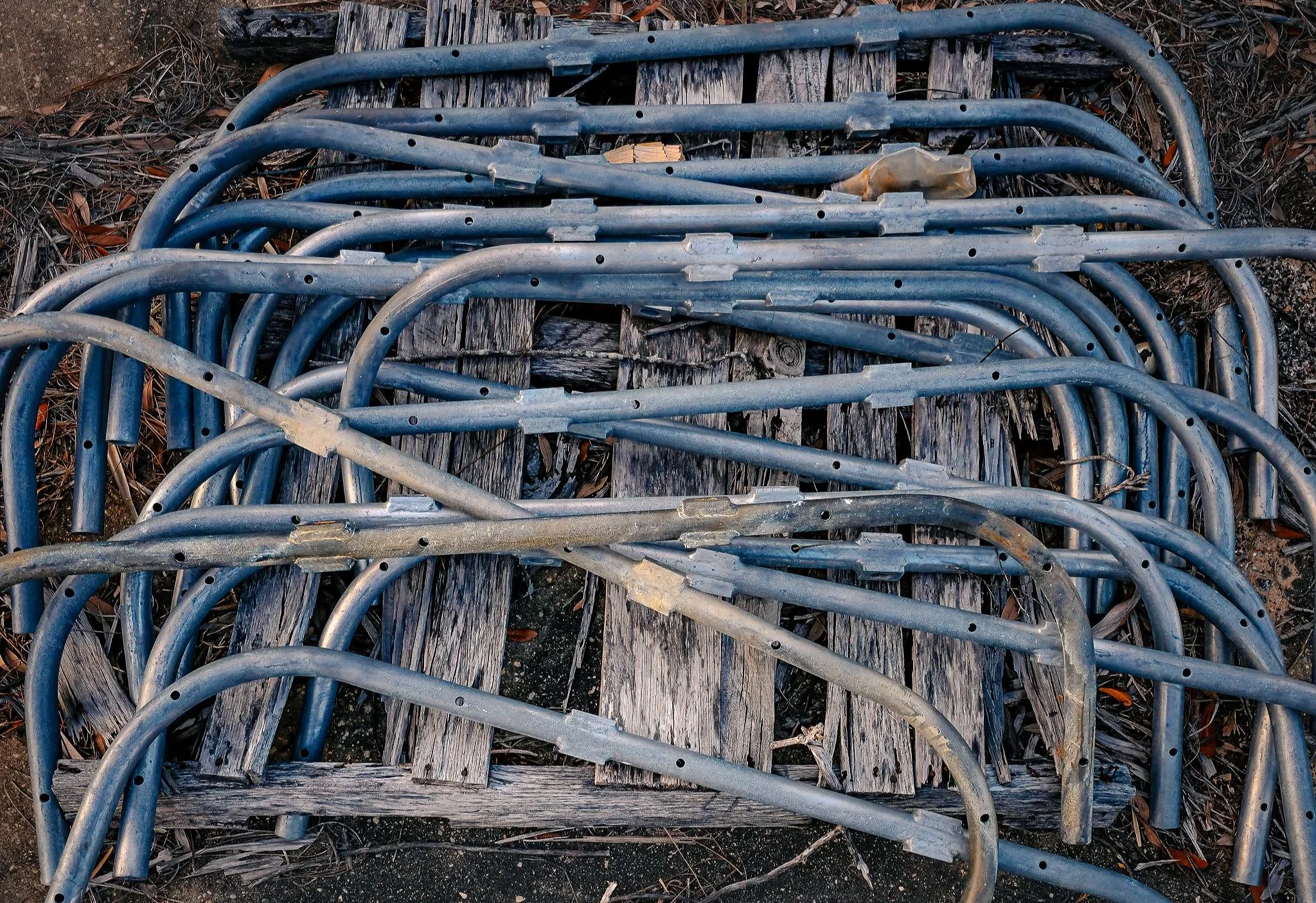 A gritty close-up of aluminum racks, emphasizing texture, repetition, and industrial form. This photograph captures the raw foundation stage of building and infrastructure work, making it useful as industrial wall decor, construction-themed photograp