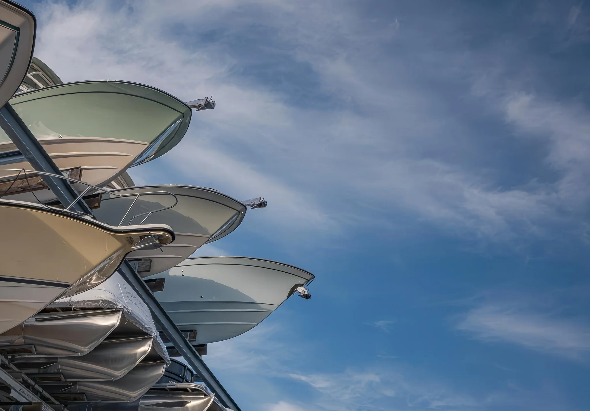 A bold marina-industrial photography piece featuring curved boat-rack structures rising against a bright Gulf Coast sky. This image blends abstract design, engineering detail, and coastal atmosphere, making it a strong fit for modern wall art, marina