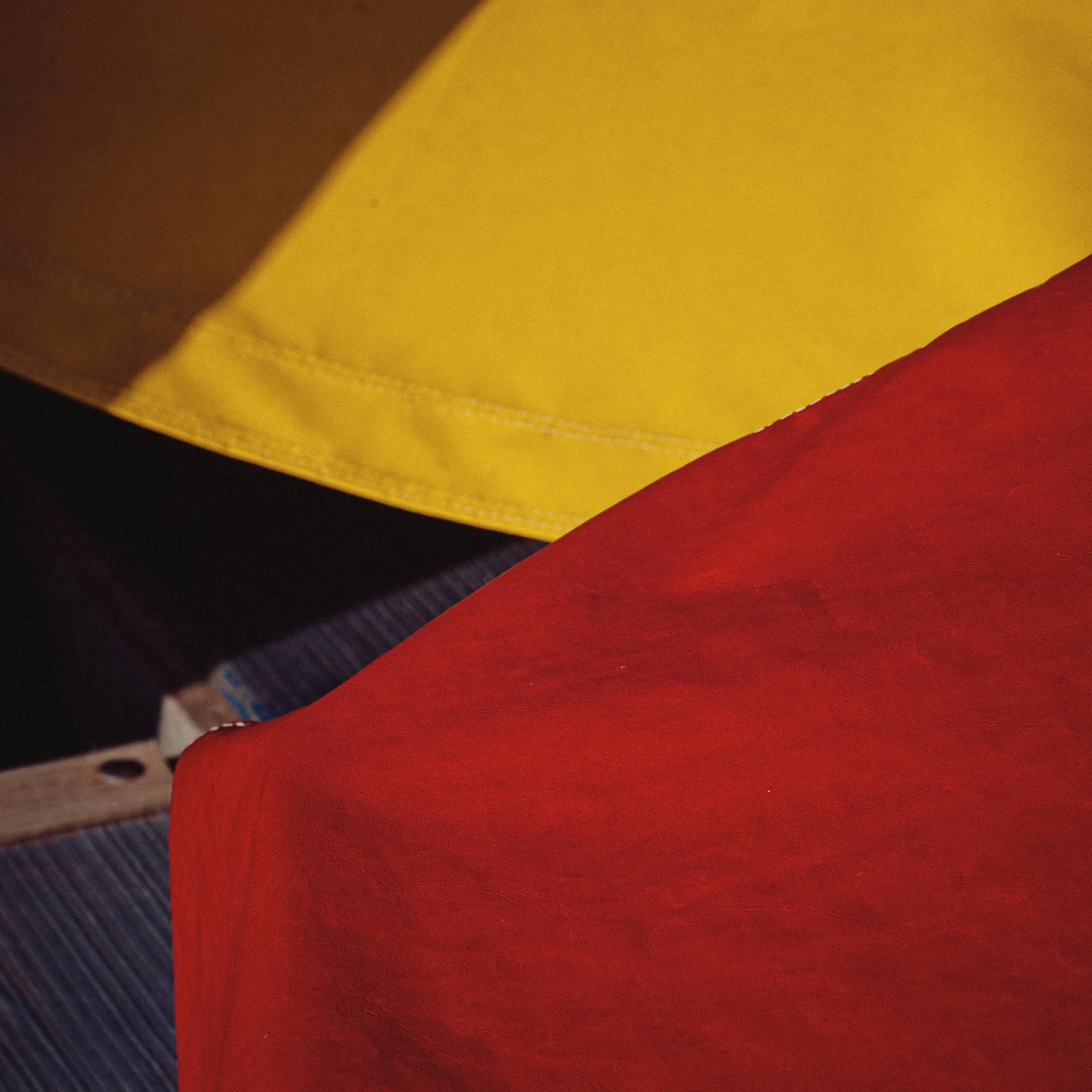 Close-up of a red, yellow, and black object with textured and smooth surfaces.
