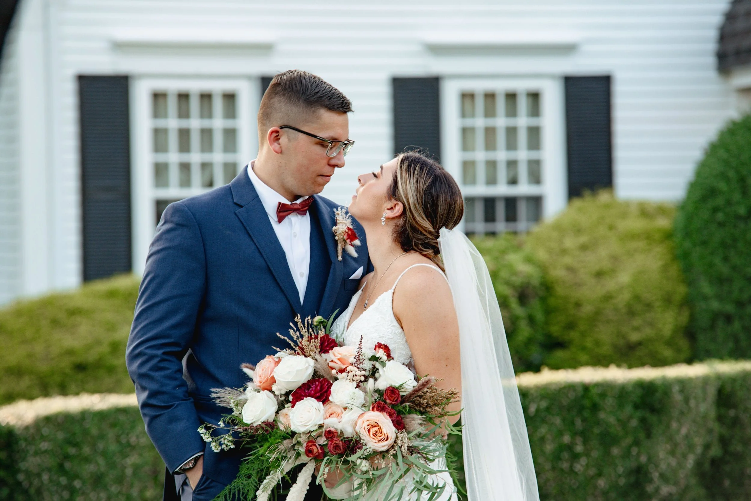 Portrait of a bride and groom facing each other, and looking into each others eyes