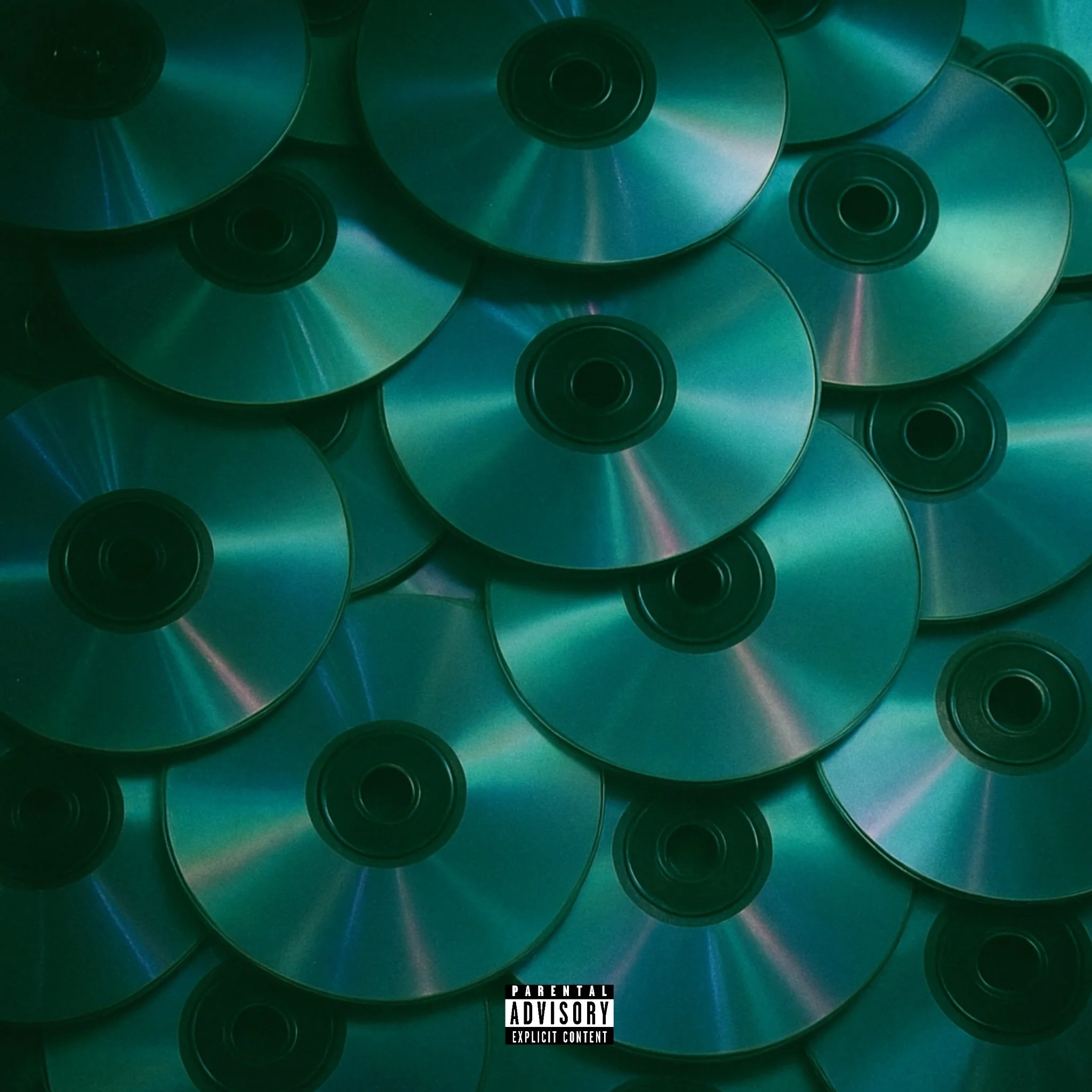 A pile of CDs with a reflective, multicolored surface, overlapping each other, with a parental advisory sticker at the bottom.
