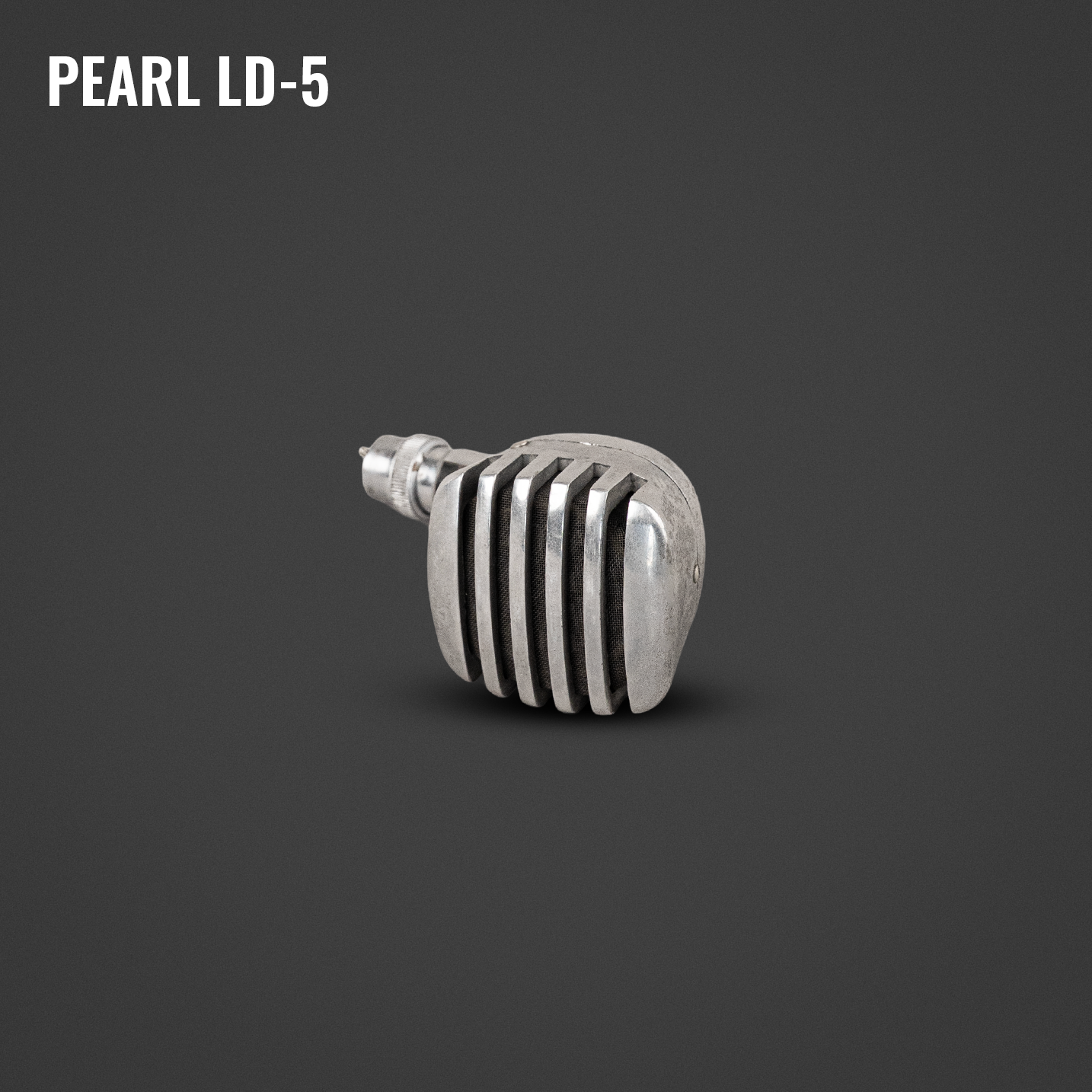 A vintage silver-colored motorcycle or car engine cylinder head with cooling fins, positioned on a dark gray background.