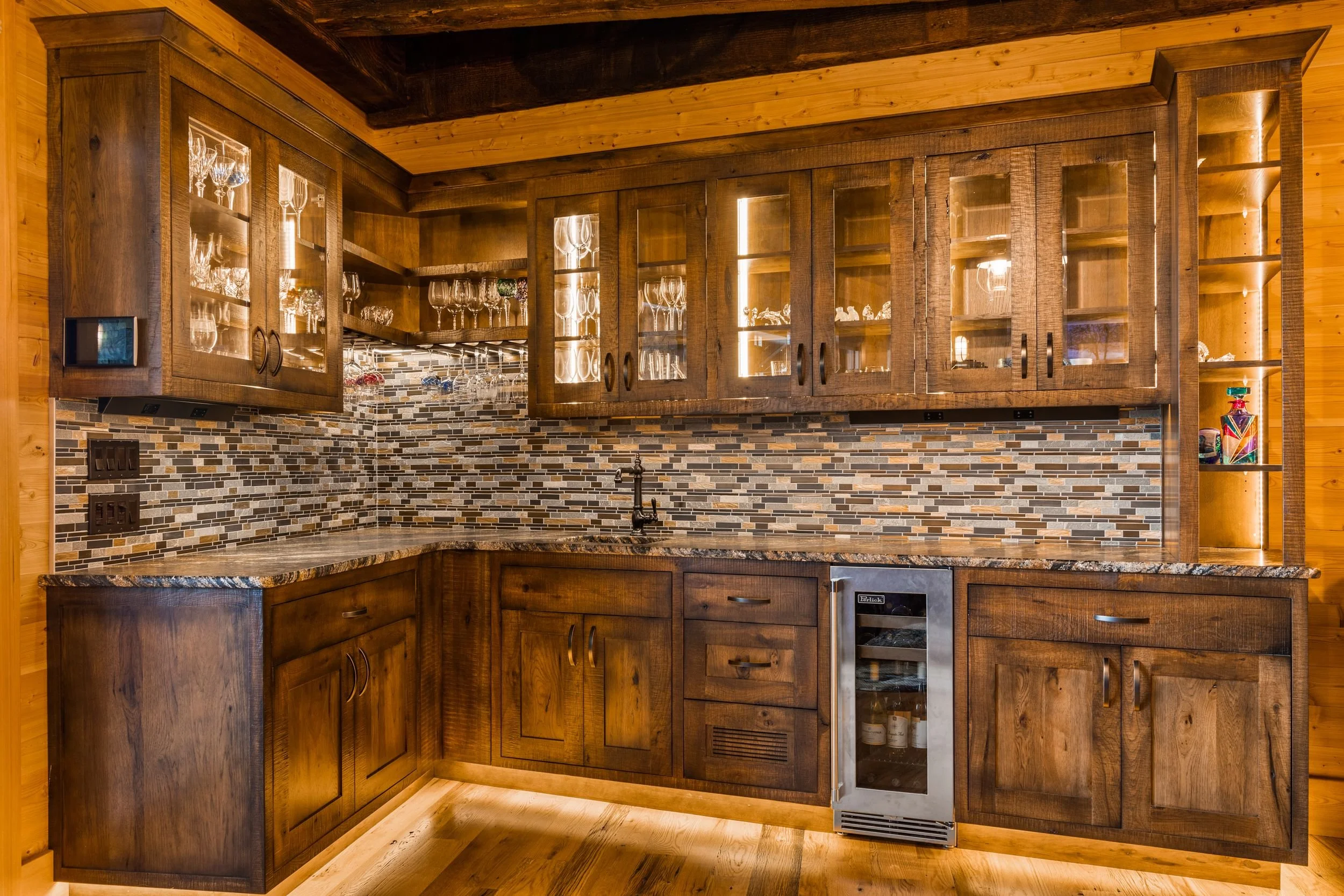 Wooden kitchen cabinets with glass doors, a mosaic tile backsplash, a granite countertop, and a small wine cooler.