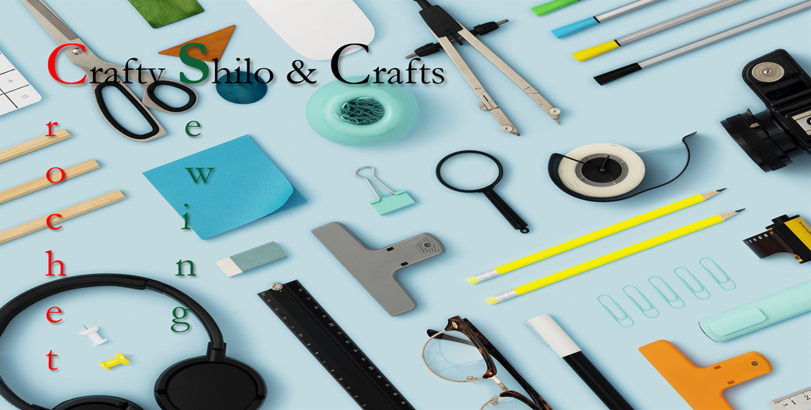 A flat lay of various stationery and craft supplies on a light blue background, including scissors, a compass, tape, pencils, paper clips, a magnifying glass, glasses, a ruler, and other craft tools with the text 'Crafty Shilo & Crafts' overlayed.