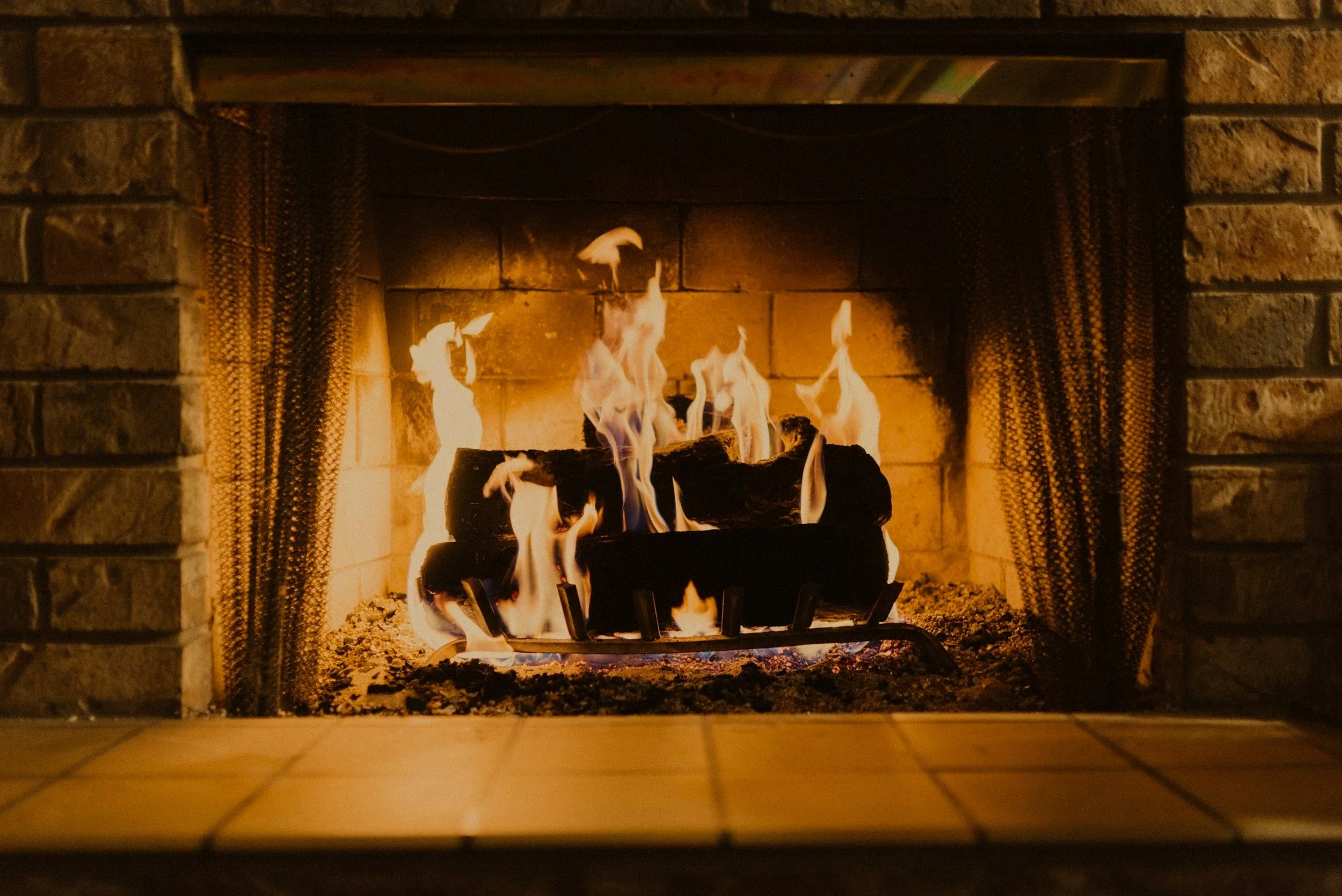 Wood-burning fireplace operating safely inside a professionally serviced residential chimney
