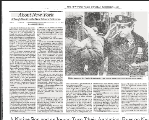 A newspaper article with a black and white photograph showing two police officers in uniform. One officer is making hand gestures while the other looks on.